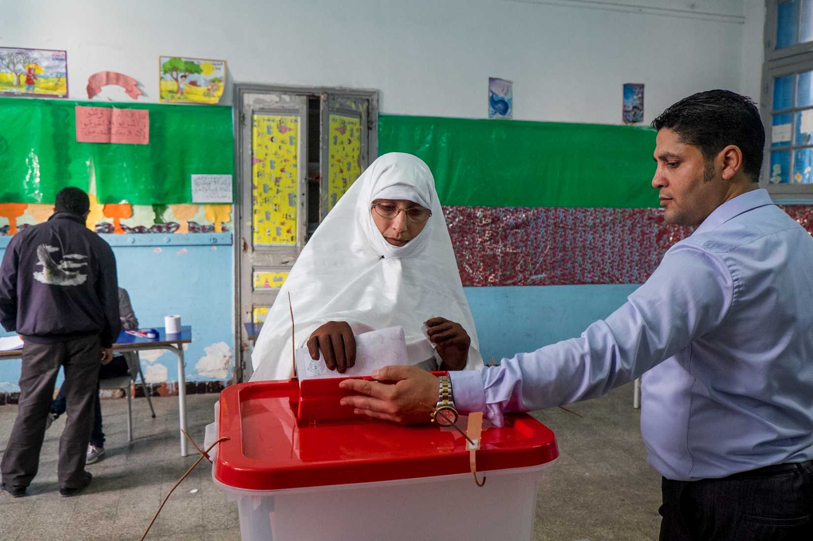 A Tunisian citizen casts her vote at a polling station during the Tunisian presidential election on Nov. 23, 2014, in Fouchana, suburb of Tunis (Nicolas Fauque—Images des Tunisie/Sipa USA/AP)