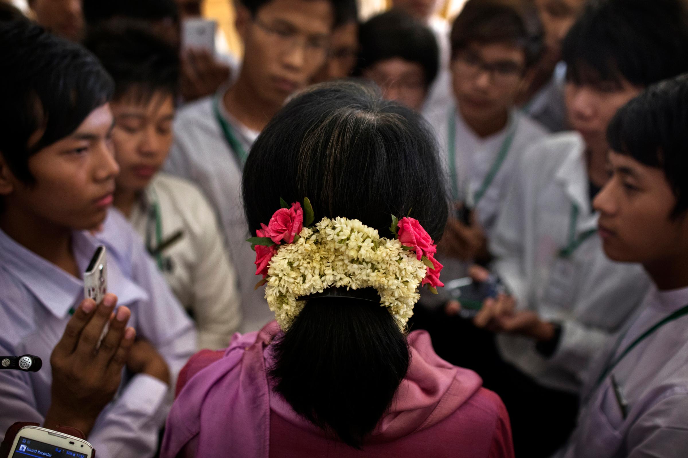 Aung San Suu Kyi talks to visiting students from Meiktila , during a break in a parliamentary session in Naypyidaw, June 20th, 2014.