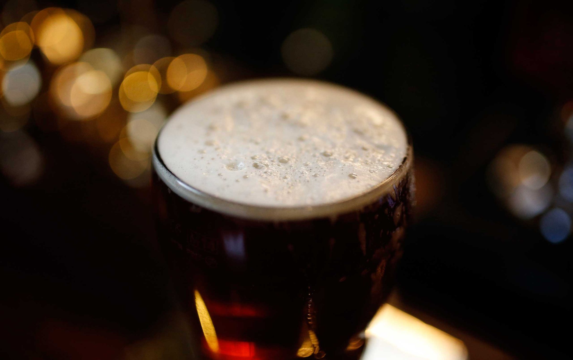 A pint of beer stands on a bar in a pub in Liverpool northern England, Nov. 19 , 2014.