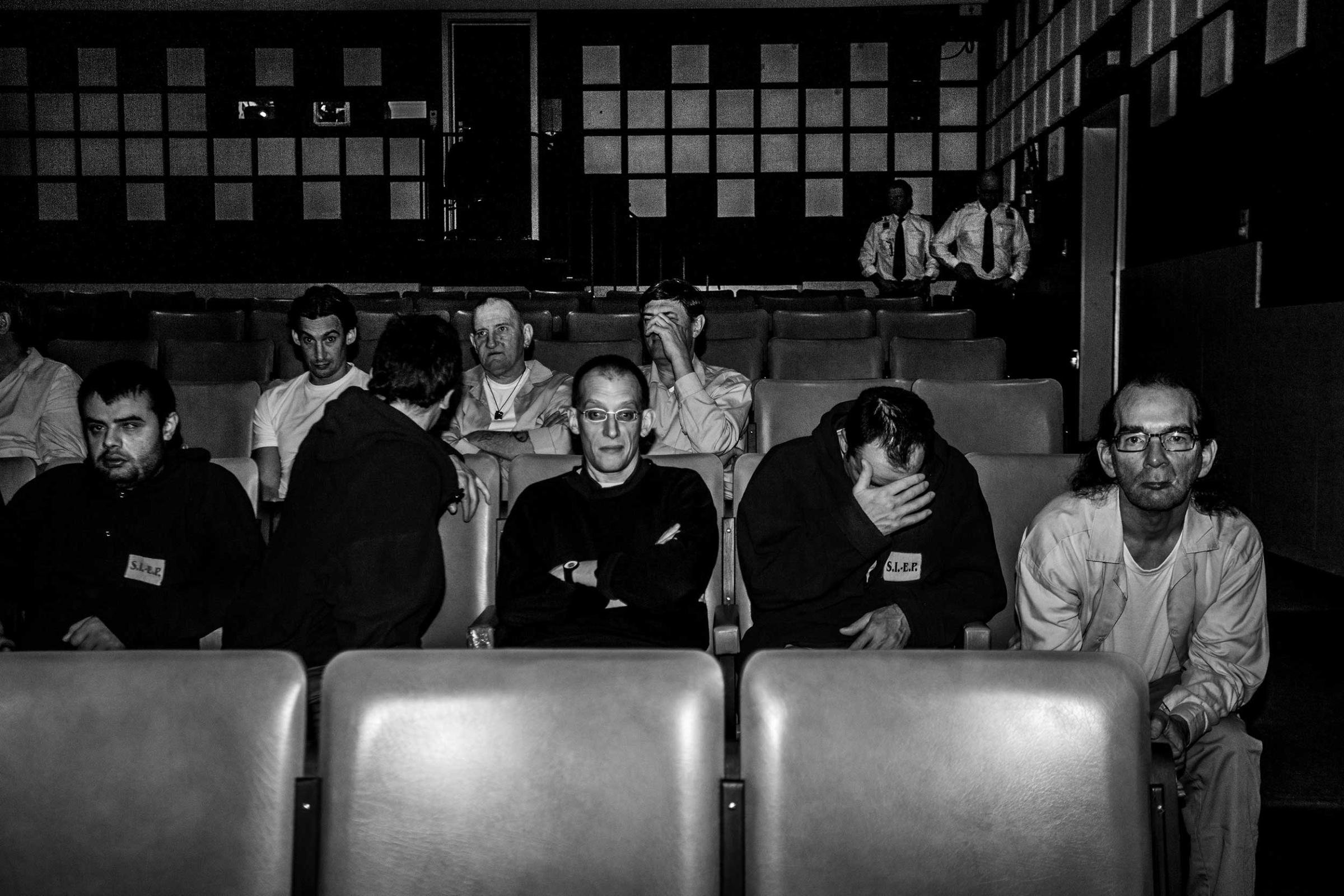 Inmates watching a film inside the movie theater of their prison in Ghent, Belgium. March 2014.