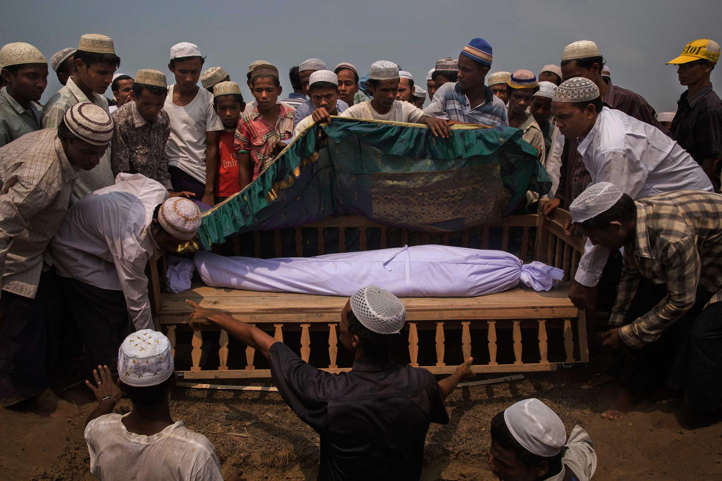 The body of Nur Husain, who died after suffering from a respiratory condition, is buried near his home in a camp near Sittwe, Myanmar. The Rohingya are a Muslim minority persecuted by Myanmar's Buddhist-led government.