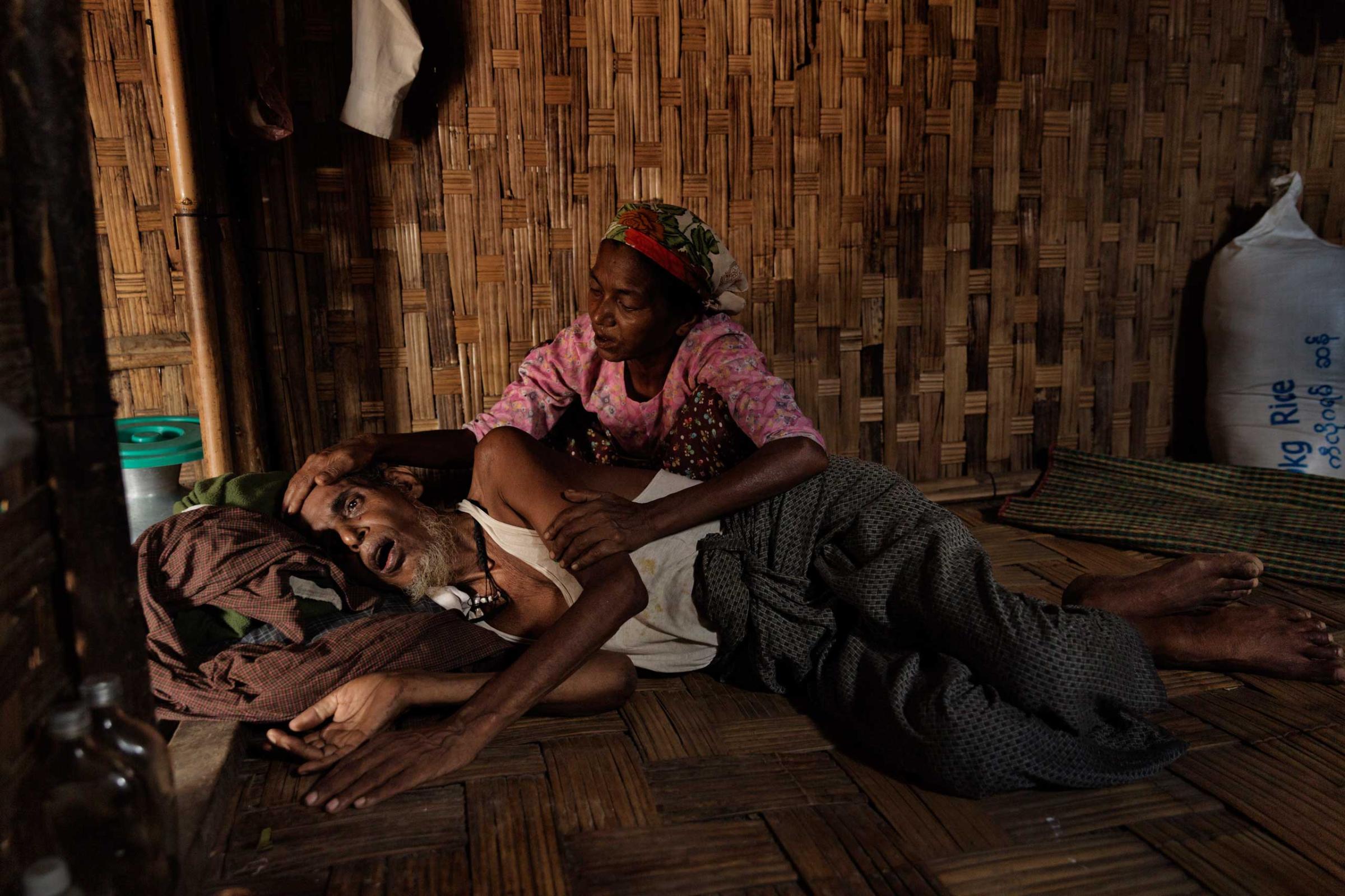 In Burma, more than 140,000 minority Rohingya Muslims have been forced to live in camps, where disease and despair have taken root. Here, Abdul Kadir, 65, who has a severe stomach ailment and malnutrition, is cared for by his wife in one of the camps, June 9, 2014.