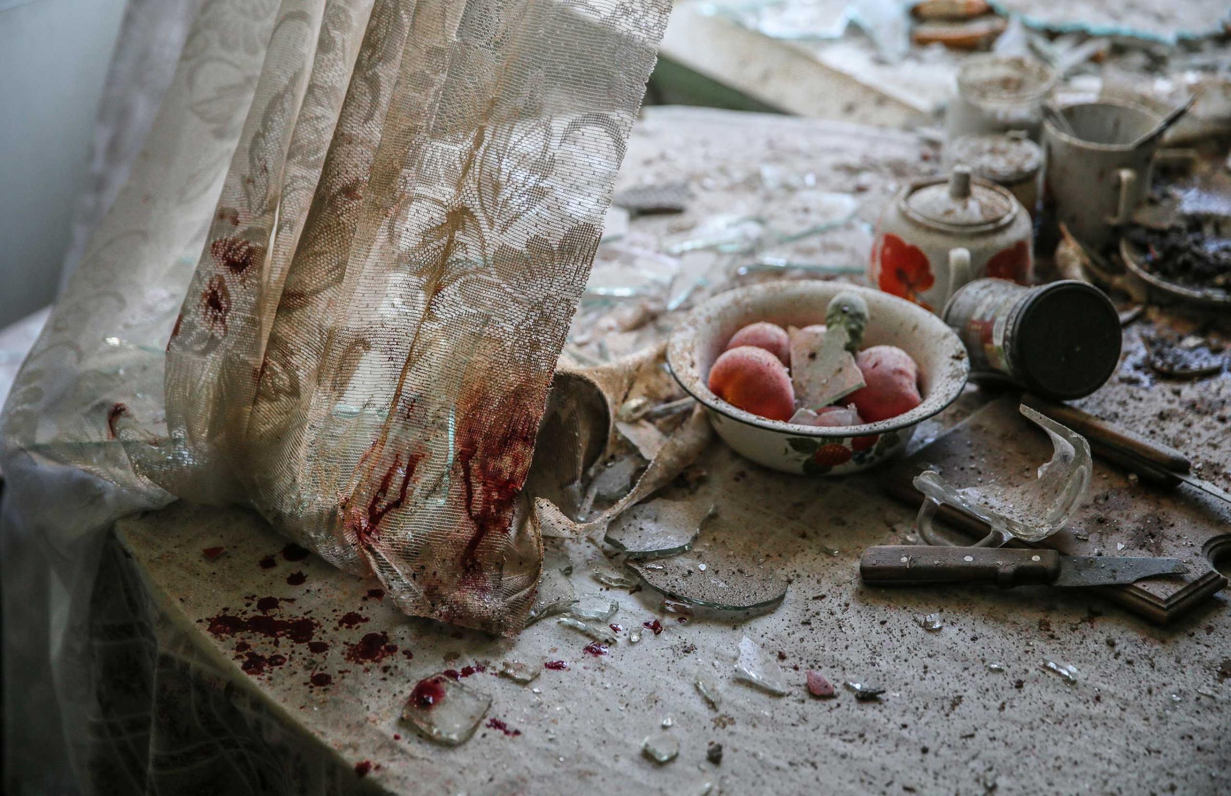 Damaged goods lie in a damaged kitchen in downtown Donetsk, Ukraine, Aug. 26, 2014.