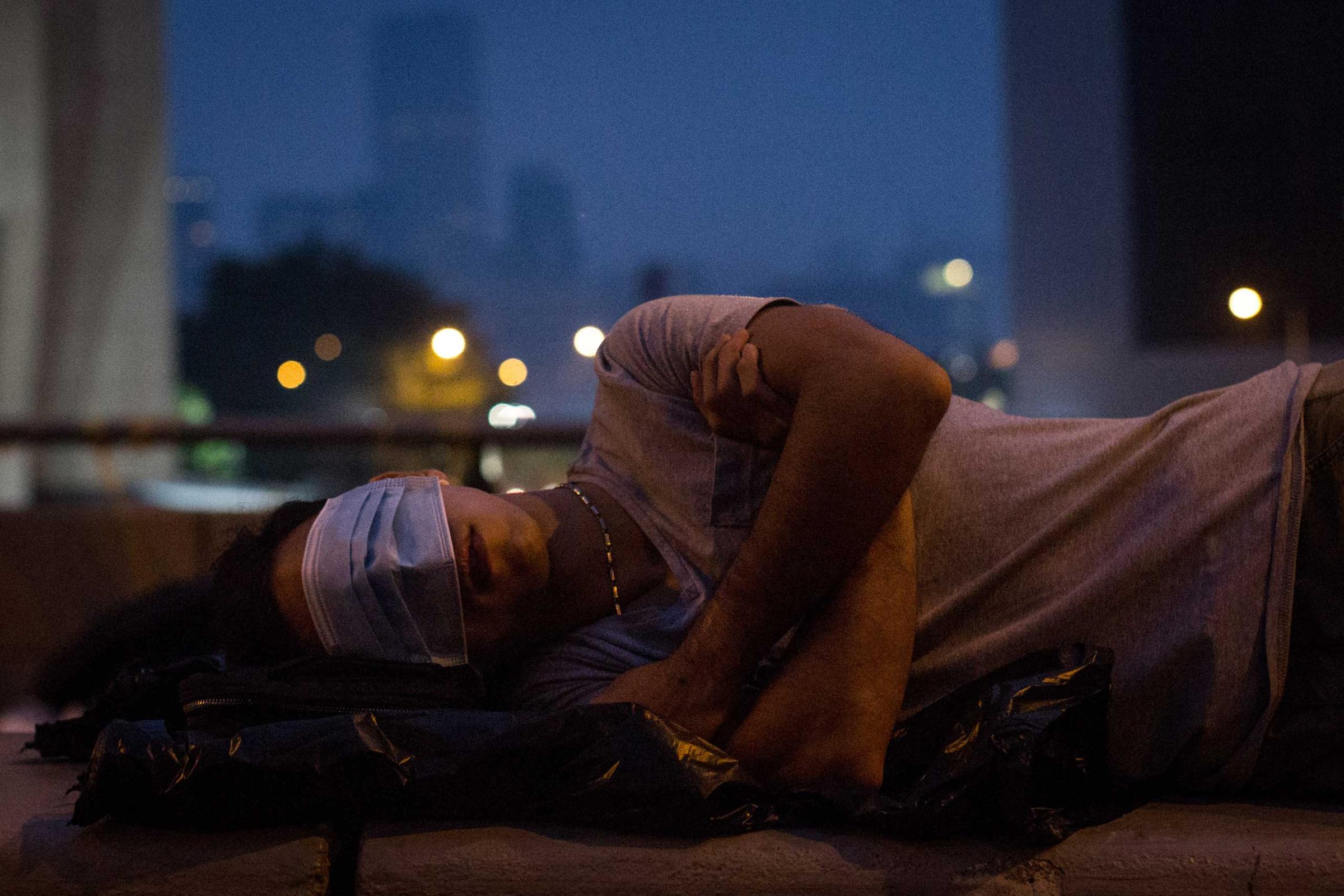 A pro-democracy protester sleeps on a concrete road divider on a street outside the Hong Kong Government Complex in Hong Kong, Oct. 5, 2014.