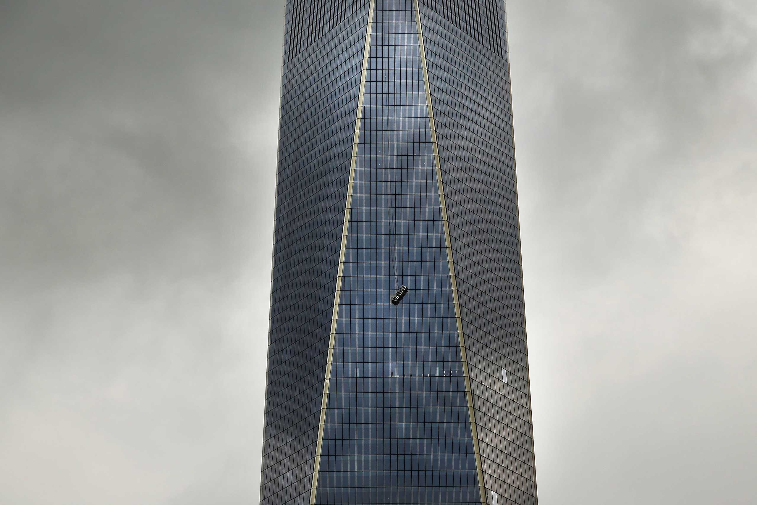 A scaffold carrying two workers hangs 69 floors up at One World Trade Center in New York City, Nov. 12, 2014.