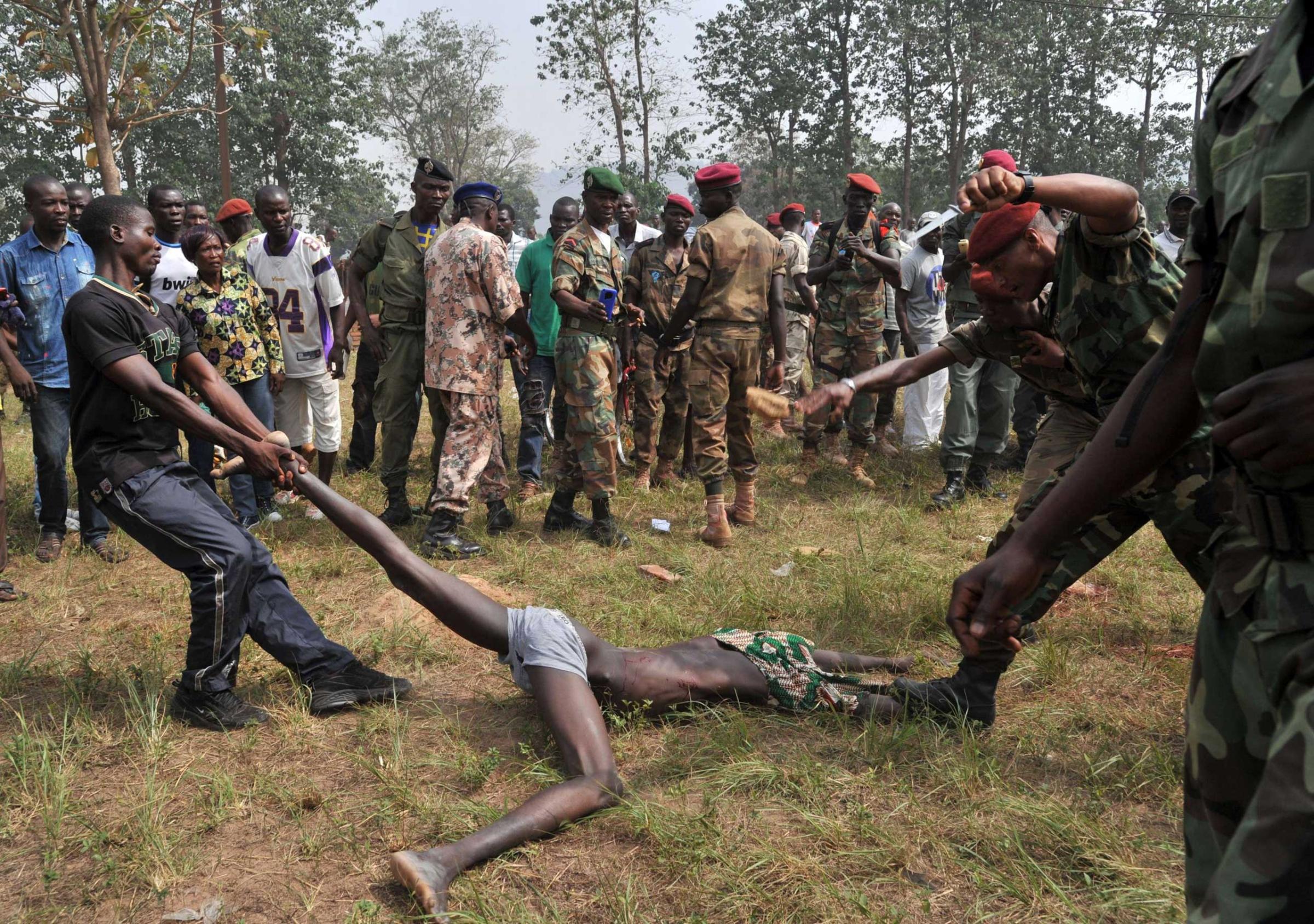 Members of the Central African Armed Forces lynch a man suspected of being a former Seleka rebel in Bangui, Feb. 5, 2014.