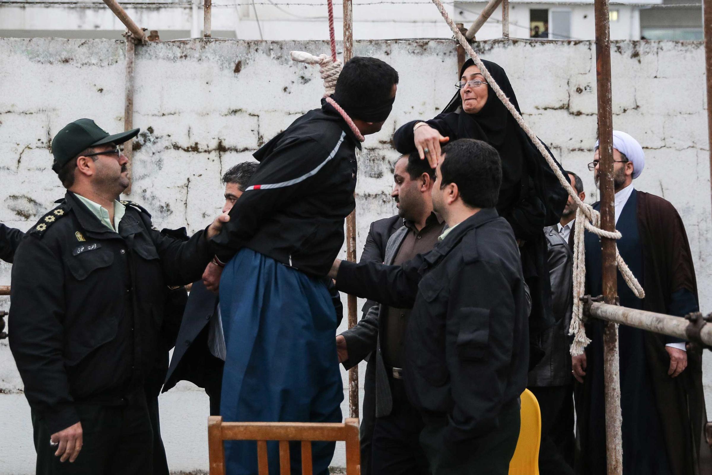 The mother of Abdolah Hosseinzadeh, who was murdered in 2007, slaps Balal who killed her son during the execution ceremony in the northern city of Nowshahr just before she removed the noose around his neck with the help of her husband, sparing the life of her son's convicted murderer, April 15, 2014.