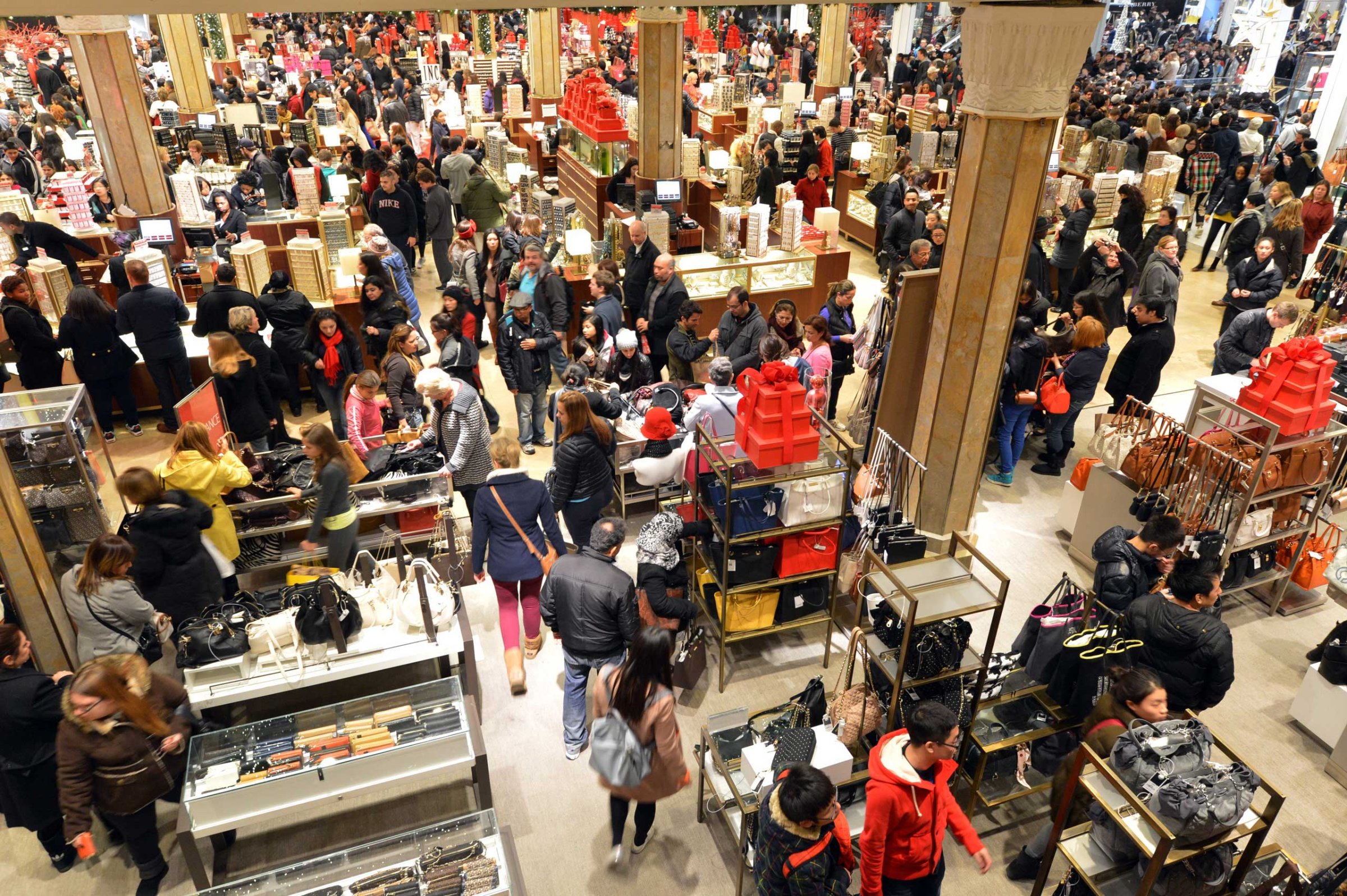 People crowd the first floor of Macy's department store as they open at midnight on Nov. 23, 2012 in New York to start the stores' "Black Friday" shopping weekend.