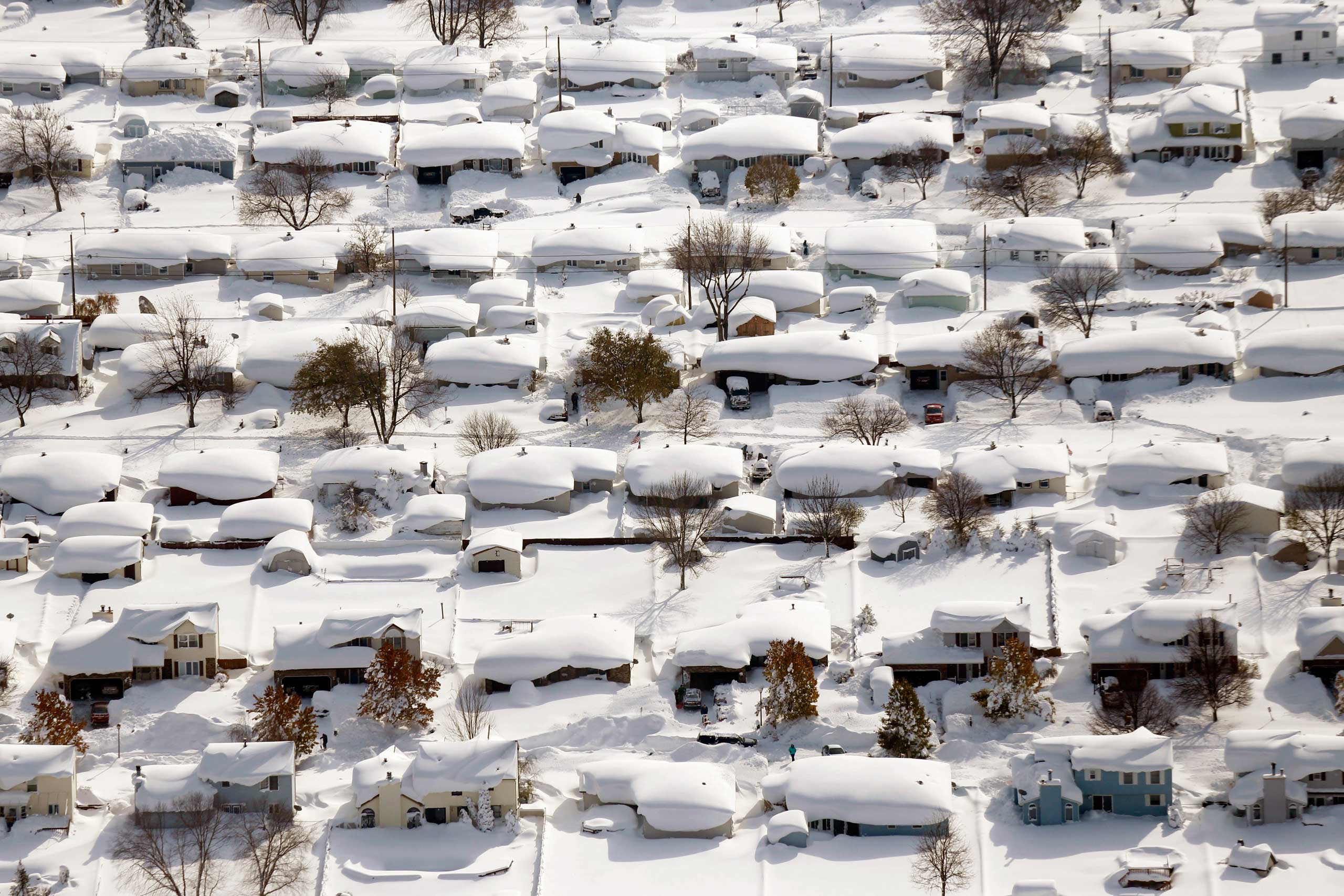 Homes are covered in snow in West Seneca, N.Y. on Nov. 19, 2014. The Buffalo area found itself buried under as much as 5½ feet of snow with another lake-effect storm expected to bring 2 to 3 more feet.