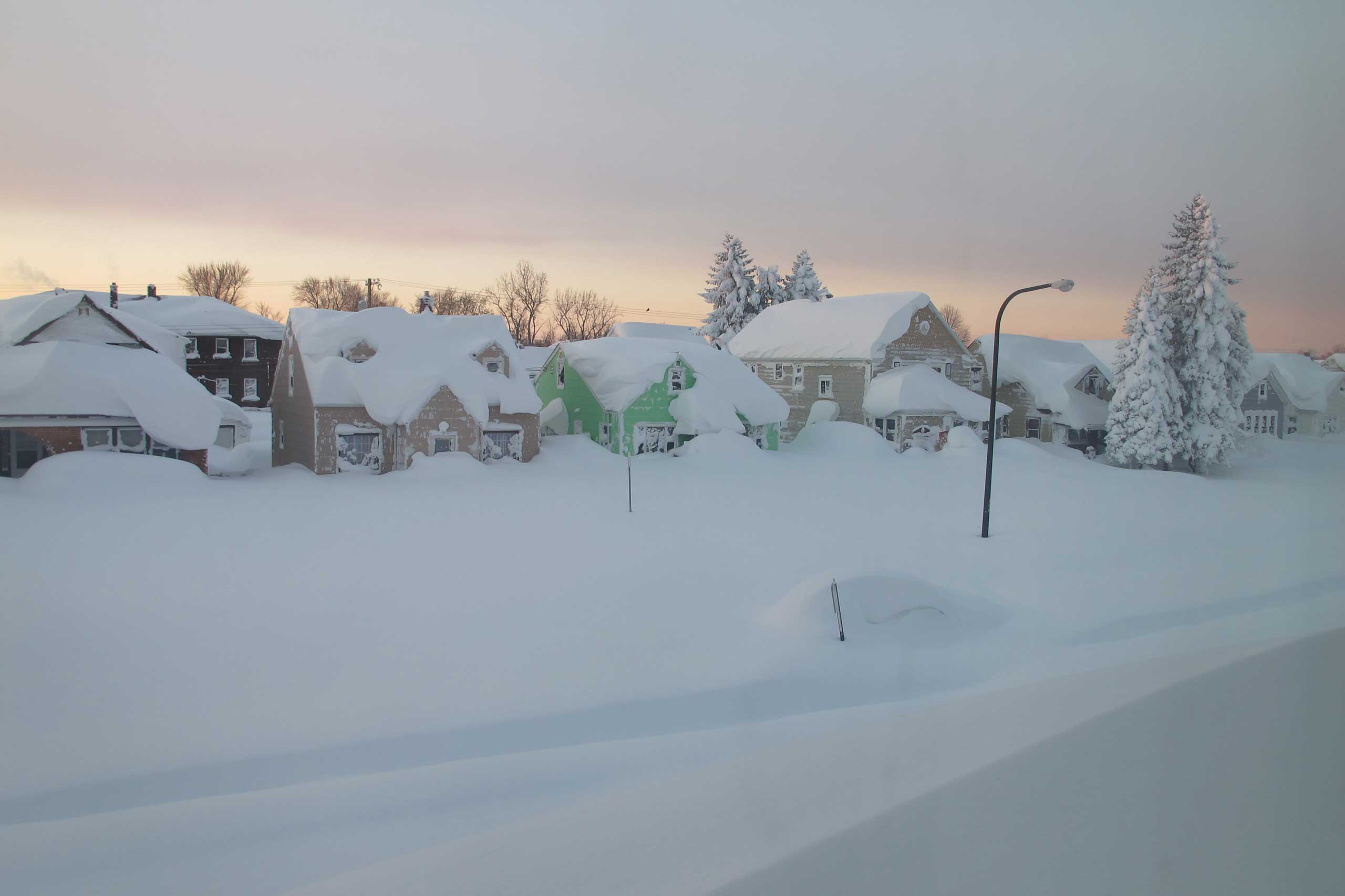 Snow covers a street at daybreak Wednesday, Nov. 19, 2014, in south Buffalo, N.Y. (Carolyn Thompson—AP)