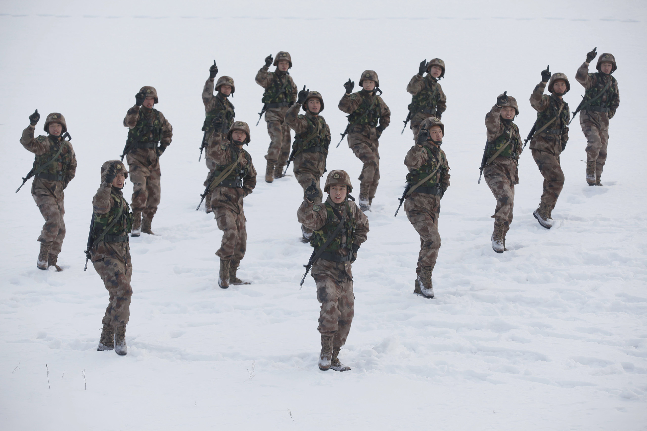 Soldiers perform the popular Little Apple dance in the snow during a training break on Nov. 11, 2014 in Heihe, China.