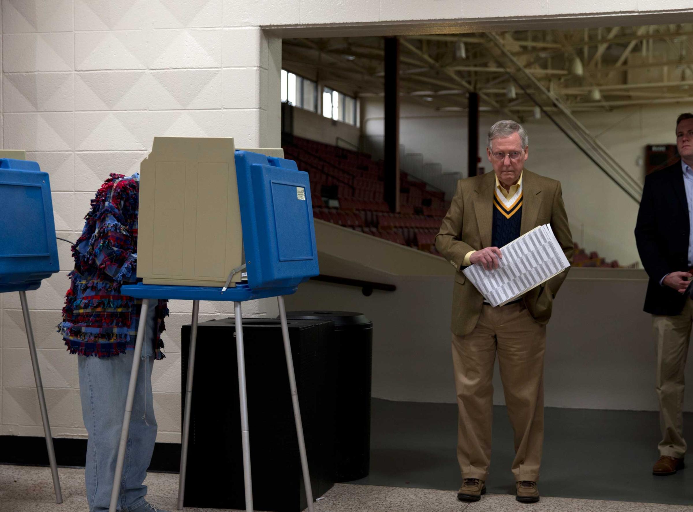 Mitch McConnell, the senior Senator from Kentucky, votes in the midterm election at Bellarmine University Knights Hall Hallway in Louisville, Ky. on Nov. 4, 2014.