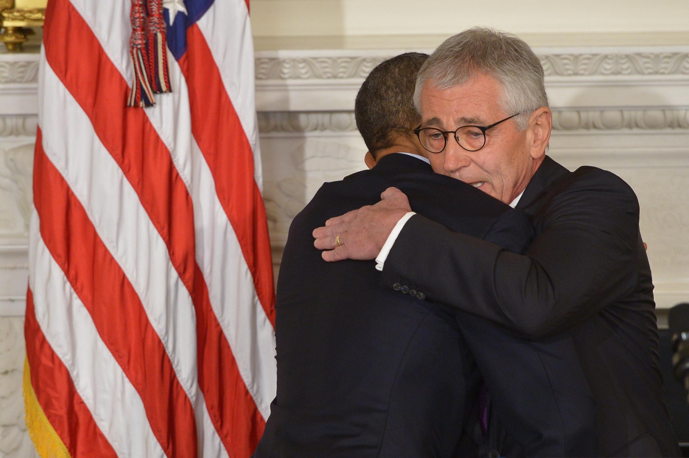 President Barack Obama and Defense Secretary Chuck Hagel embrace during a press conference to announce Hagel's departure at the White House on Nov. 24, 2014 in Washington, DC.