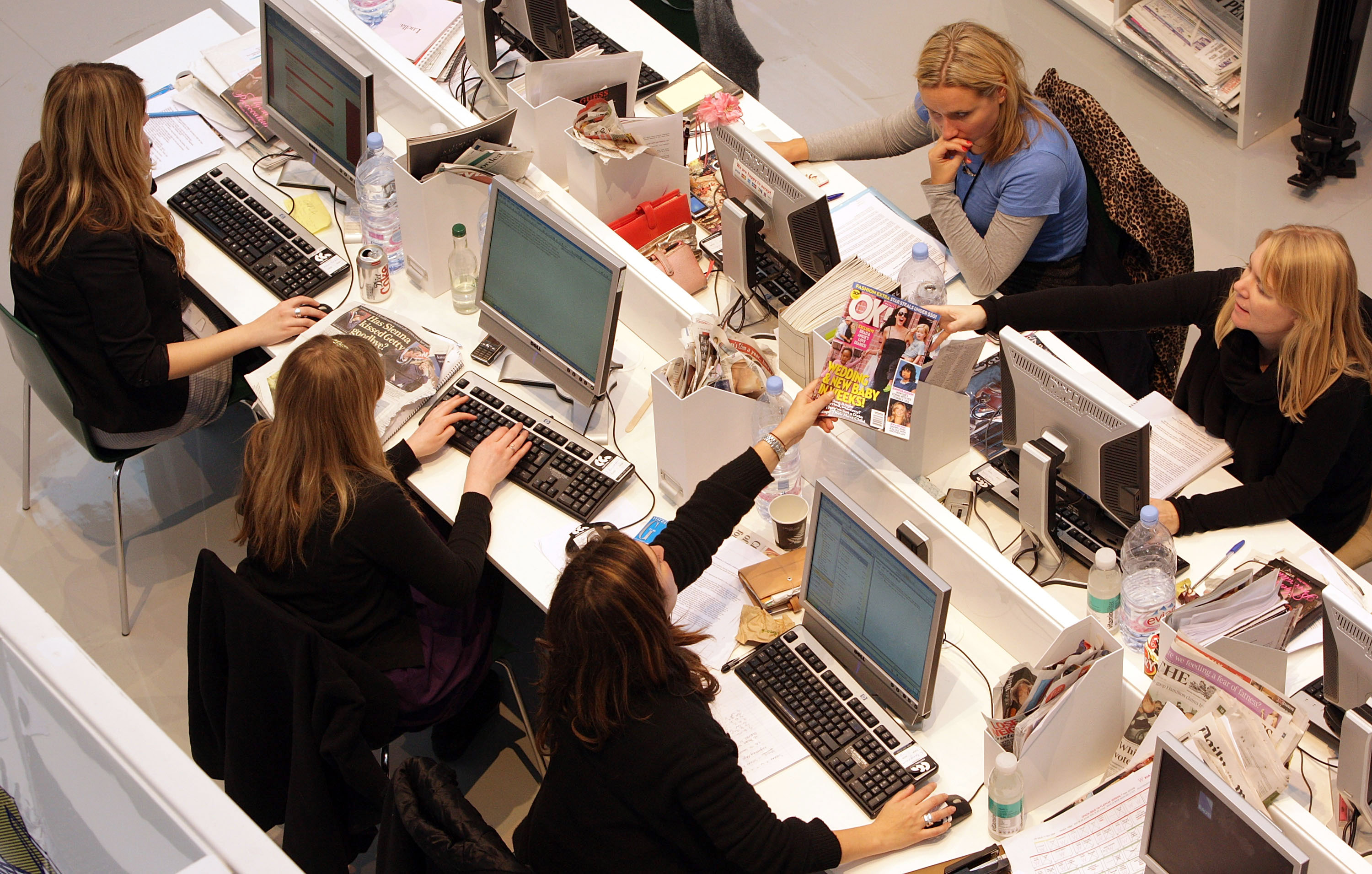 Production staff on the weekly fashion magazine, Grazia edit the magazine in a temporary office inside the Westfield shopping centre on November 3, 2008 in London. (Oli Scarff—Getty Images)
