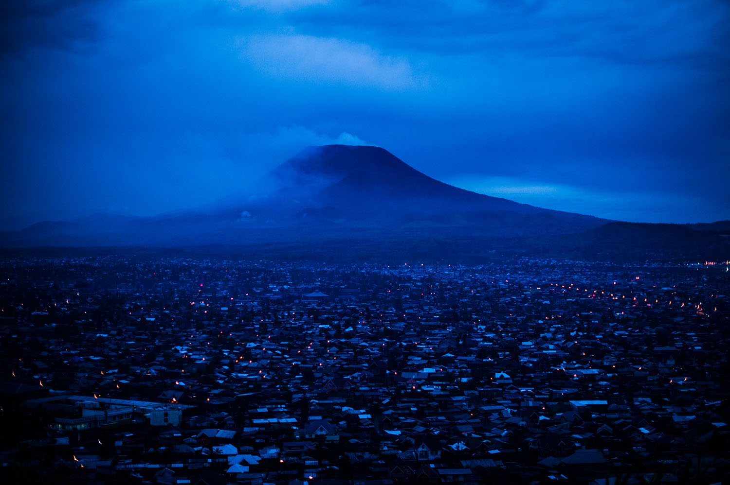 Al Jazeera: Democratic Republic of Congo's deadly volcanoThe city of Goma lies at the foot of Mount Nyiragongo, an active volcano situated around 12 miles from the city, as seen in the evening of Nov.1, 2013 in the east of the Democratic Republic of Congo. Mount Nyiragongo last erupted in 2002, destroying around 15% of the city, leaving some 120,000 people homeless.