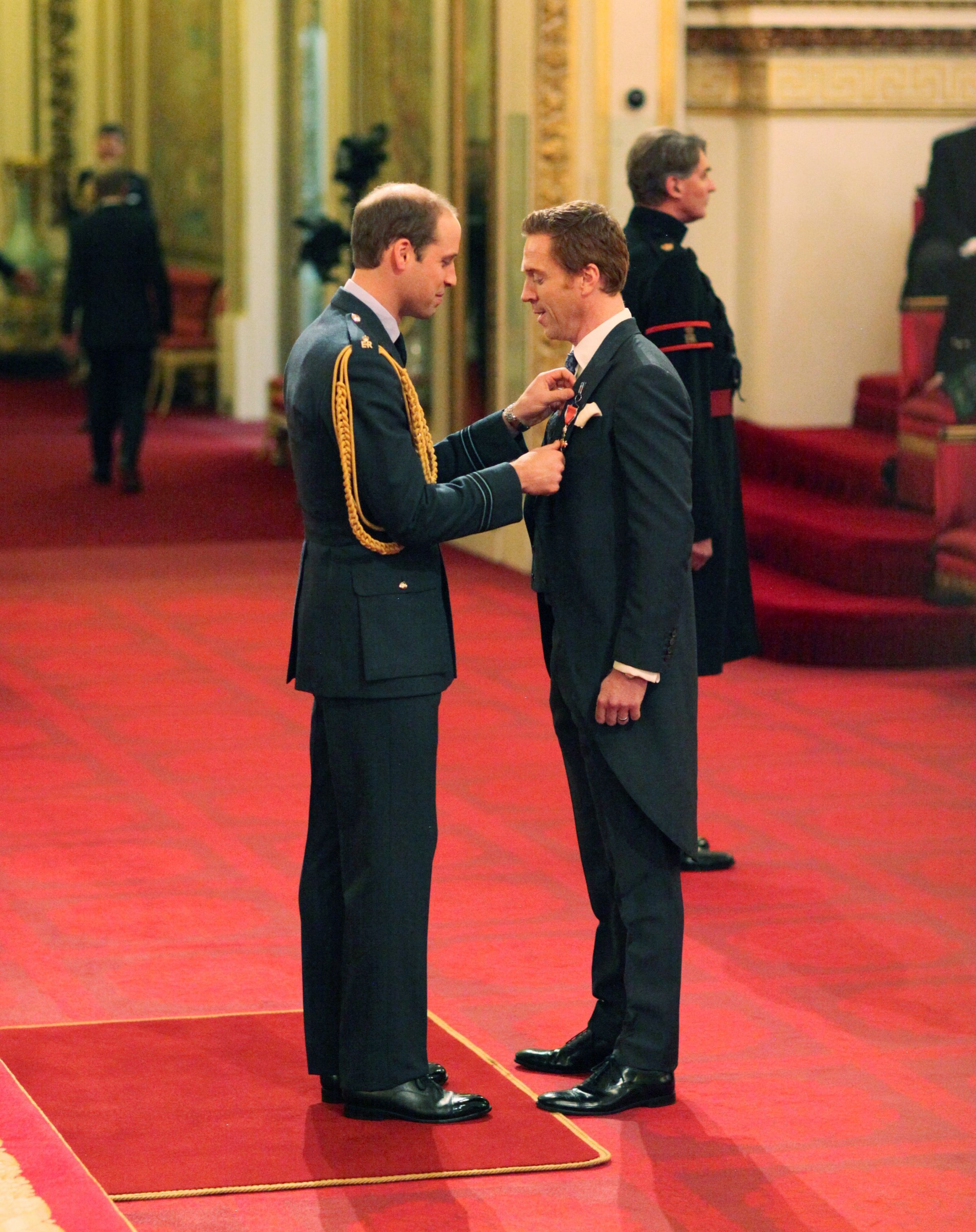 Investitures at Buckingham Palace. Damian Lewis from London is made an Officer of the Order of the British Empire (OBE) by the Duke of Cambridge during an Investiture ceremony at Buckingham Palace on Nov. 26, 2014.