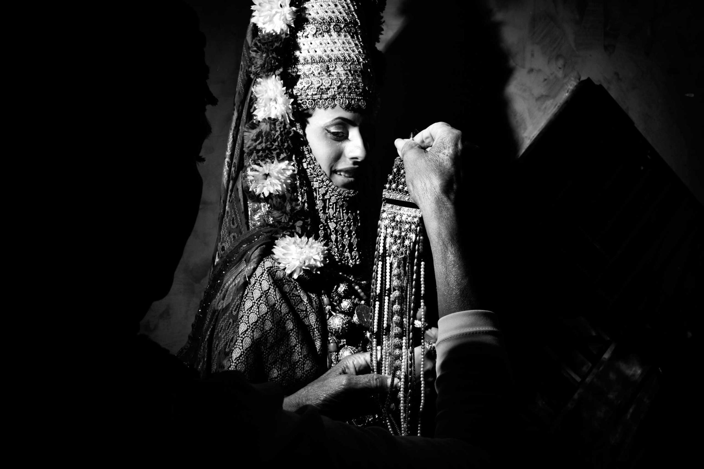 The henna is a pre-nuptial cerimony celebrated in Moroccan or Yemenite families where the soon-to-be bride is dressed-up as a Queen with flowers and jewels and she is inivited to dance with her girl friends to say good-bye to celibacy and life as a single young girl. During the dance cerimony, the Kallah, the bride-to-be's hands and feet are painted with henne`, the red pouder from India. This welcomes fertility and happinesses within the marriage. Meah Shearim, Jerusalem, Israel. July 2012.