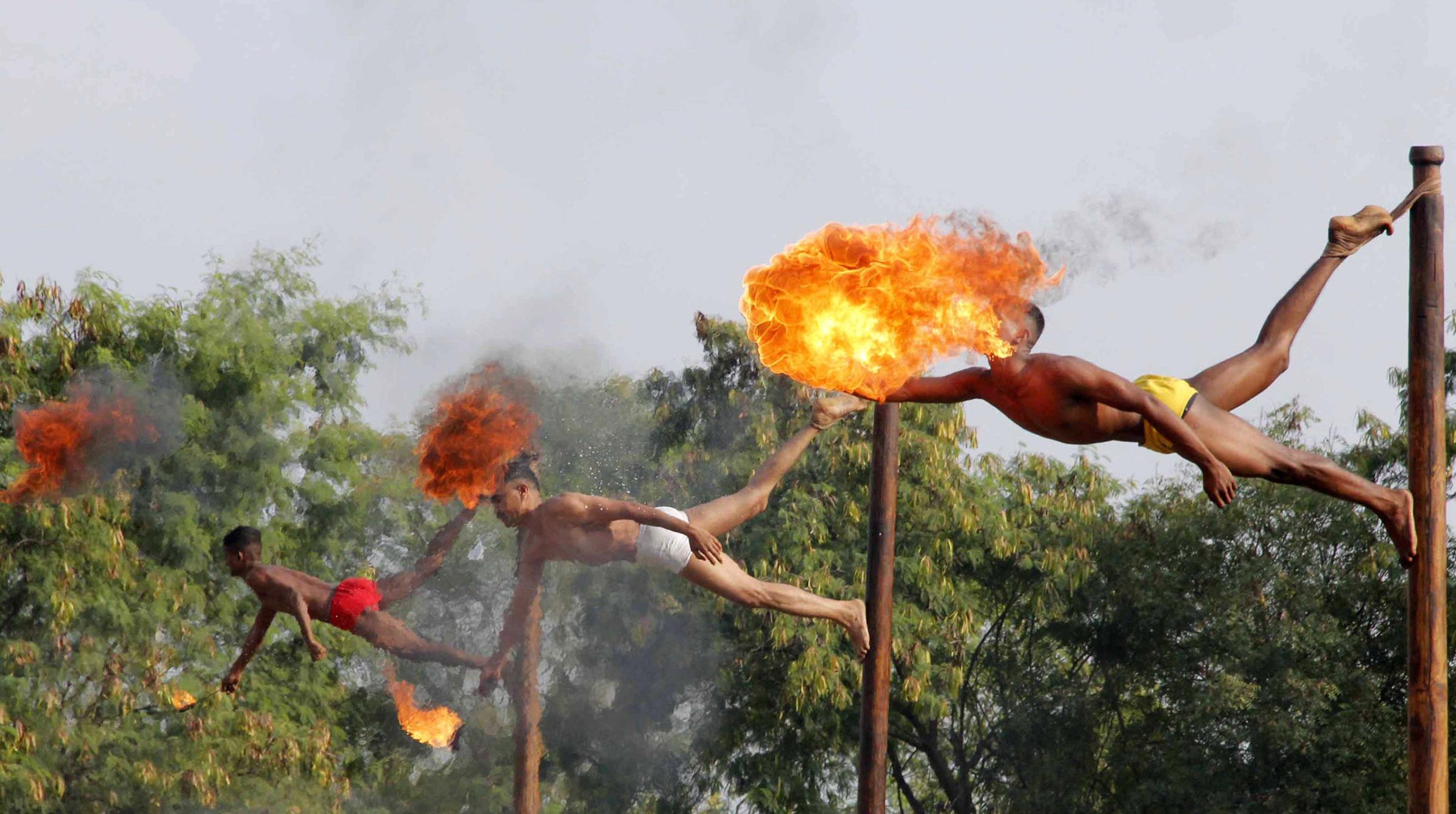Indian soldiers take part in a demonstration of 'fire breathing' at the start of Operation Hand in Hand - a joint training exercise between Indian and Chinese troops - at Aundh Military Camp in Pune, India, on Nov.18, 2014.