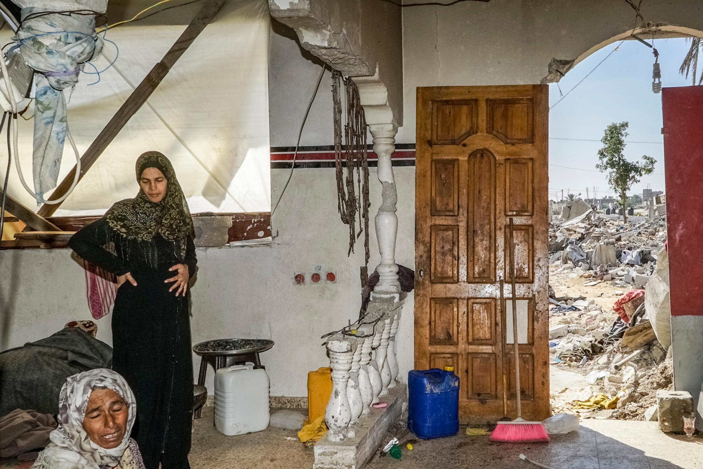 2014.  Gaza.  Palestine.The Najar family in their destroyed home.    Operation Protective Edge lasted from 8 July 2014 – 26 August 2014, killing 2,189 Palestinians of which 1,486 are believed to be civilians. 66 Israeli soldiers and 6 civilians were killed.  It's estimated that 4,564 rockets were fired at Israel by Palestinian militants.