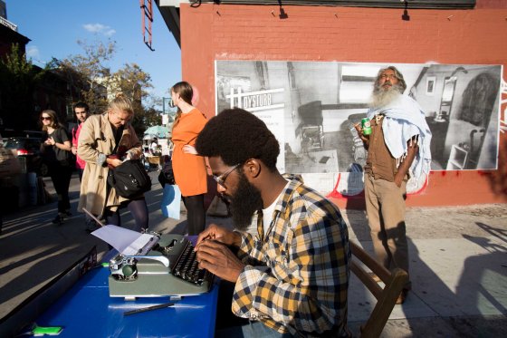 Passersby in Brooklyn, New York in front of one of Dysturb's photographs (on the corner of N 6th Street and Bedford Avenue). October 17th 2014.