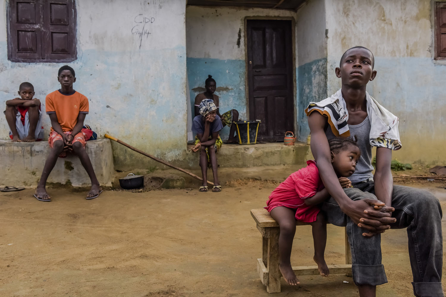 Family of Isatu Sesay, 16, an Ebola victim, grieve as they wait for a burial team to collect Sesay's body, in Kissi Town, Sierra Leone, Nov. 22, 2014.