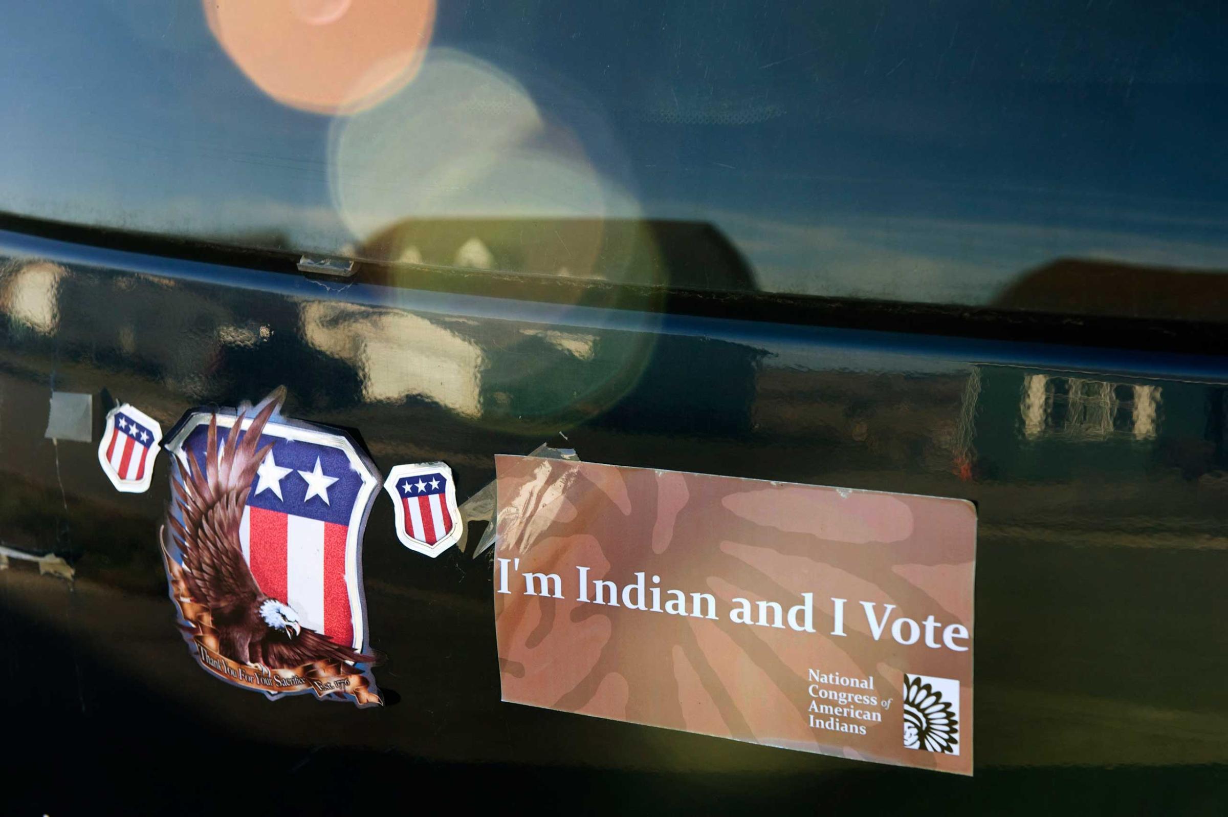 A bumper sticker stating "I'm Indian and I vote" adorns a car on the Fort Berthold Reservation in North Dakota