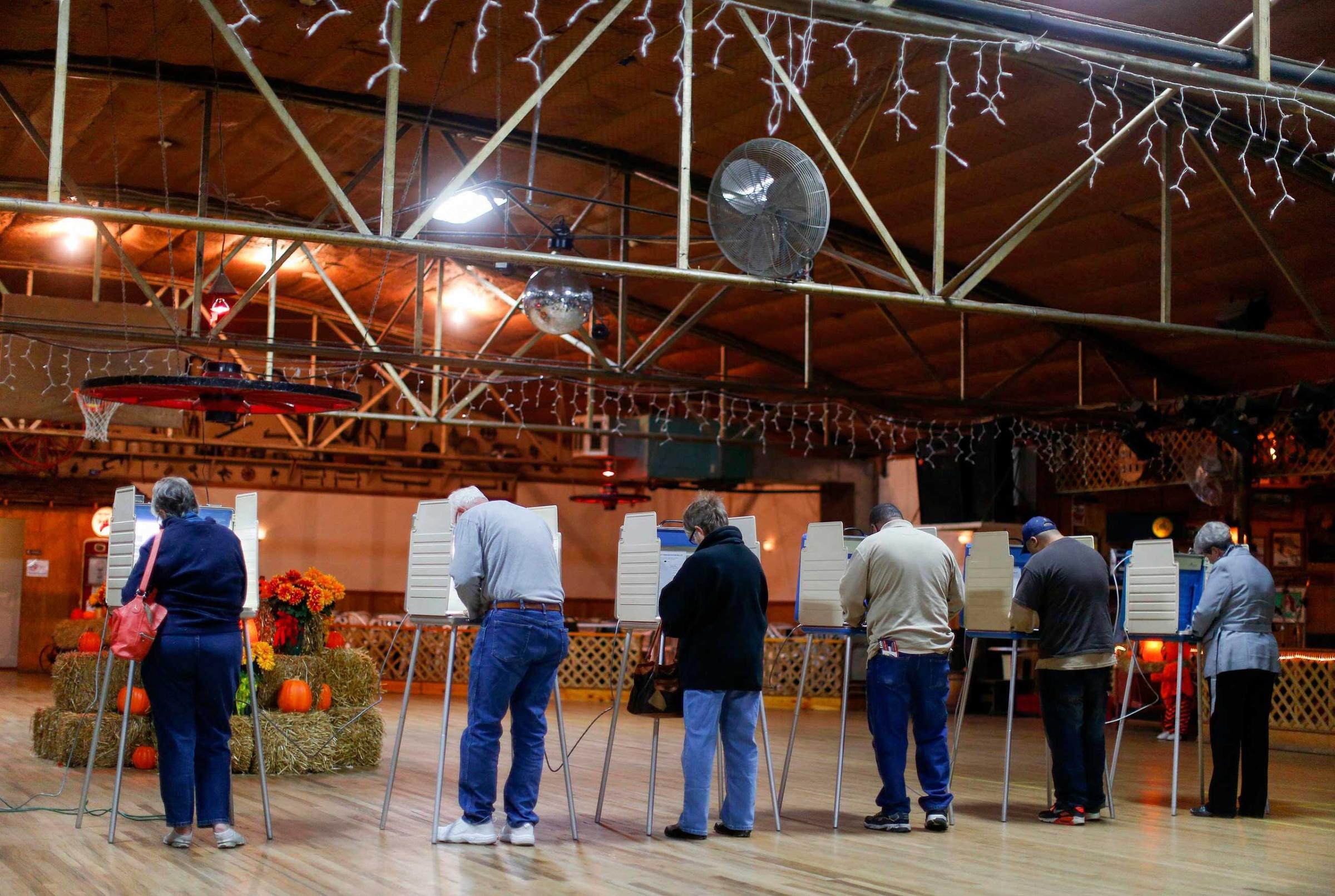 Voters fill in their ballots at a polling place located in Shoaf's Wagon Wheel during the U.S. midterm elections in Salisbury