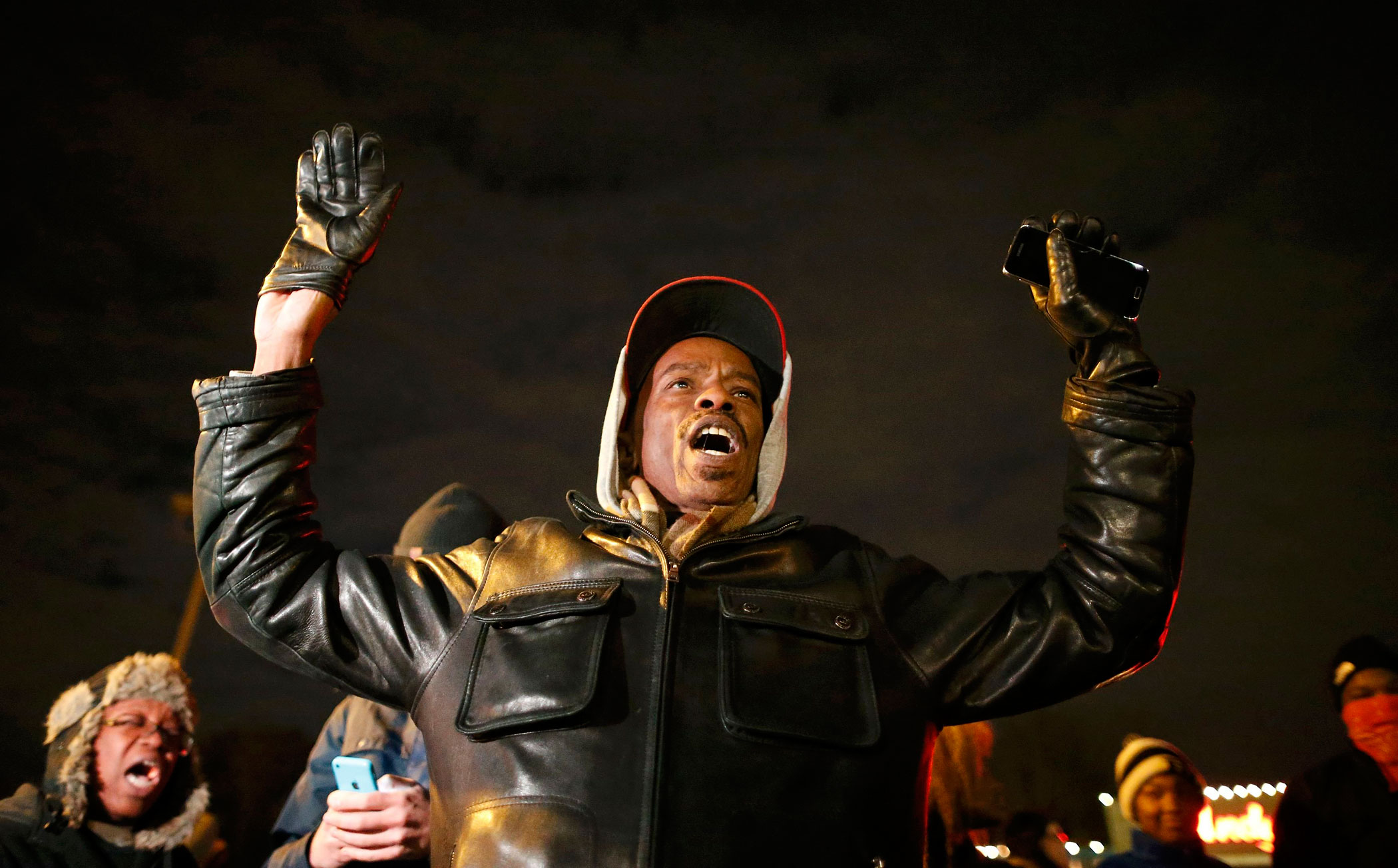 A protester holds his hands in the air outside the Ferguson Police Department in Ferguson