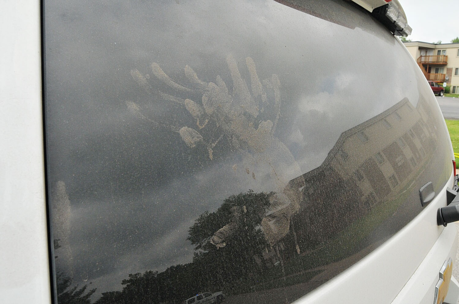 Handprints mark the rear window of Wilson's vehicle.