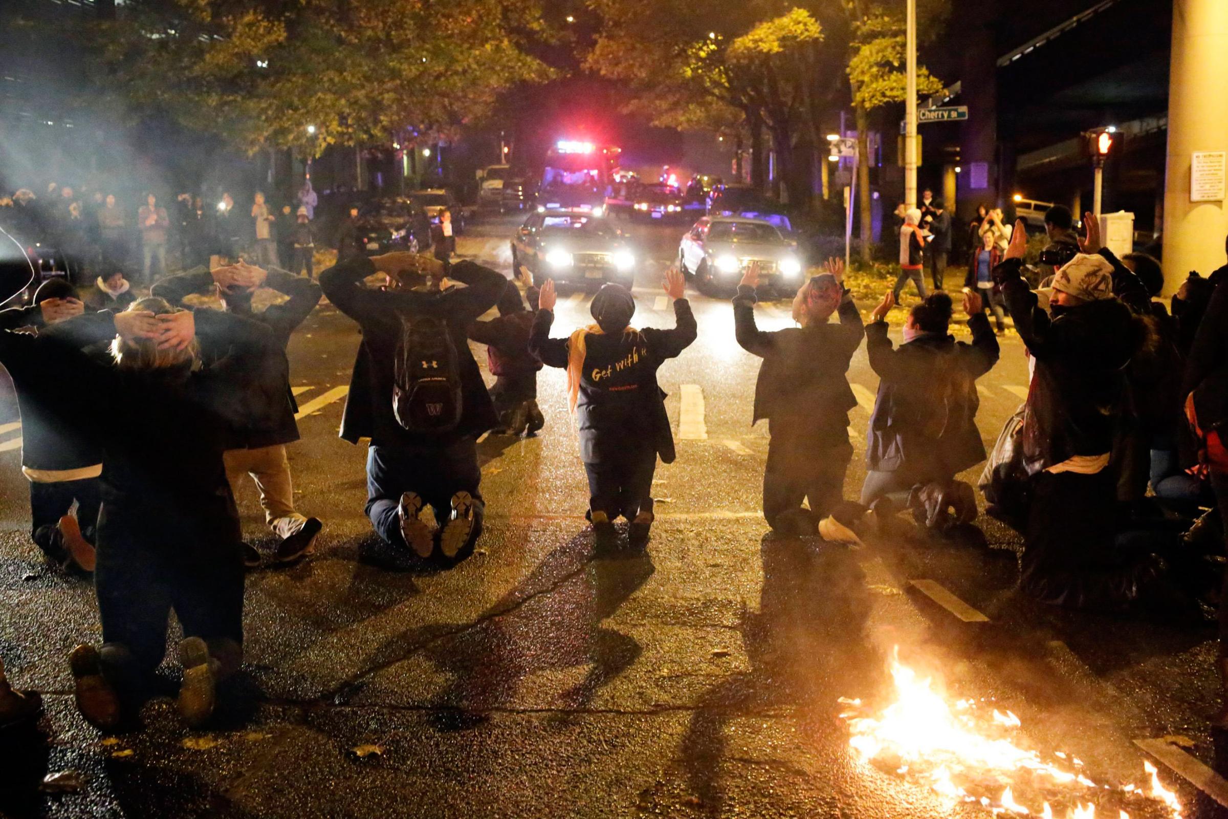 Protesters kneel during a demonstration in Seattle on Nov. 24, 2014.