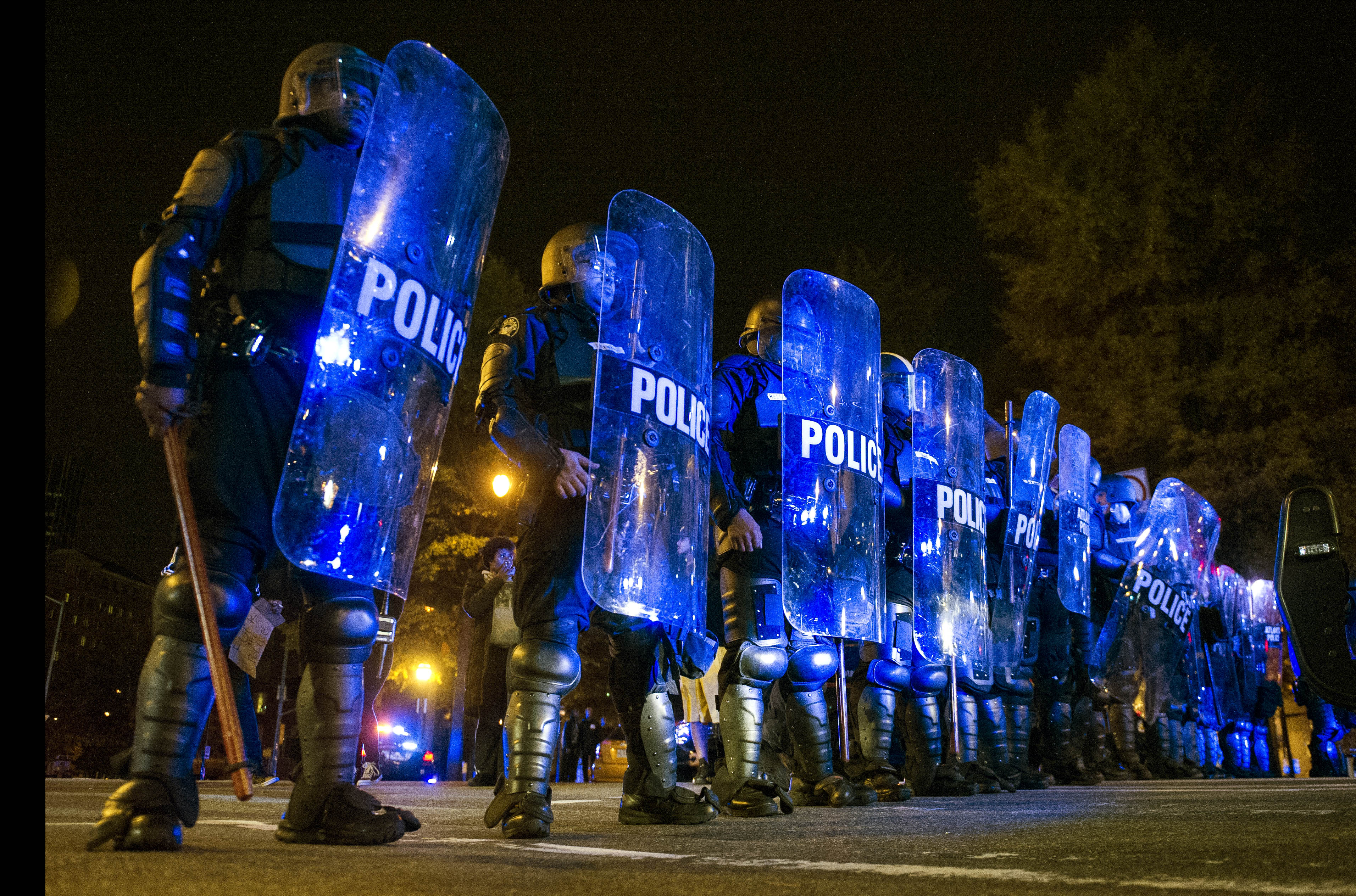 Atlanta Police in riot gear form a line on Williams Streets as protesters make their way down it in Atlanta, Ga. on Nov. 25, 2014, (John Amis—AP)