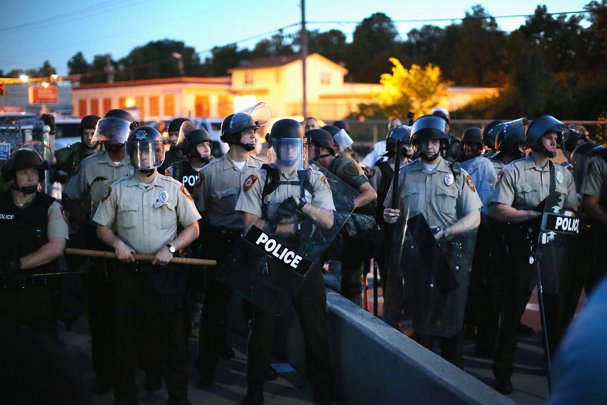 Police stand watch as demonstrators protest the shooting death of teenager Michael Brown on August 13, 2014 in Ferguson, Missouri. (Scott Olson—Getty Images)
