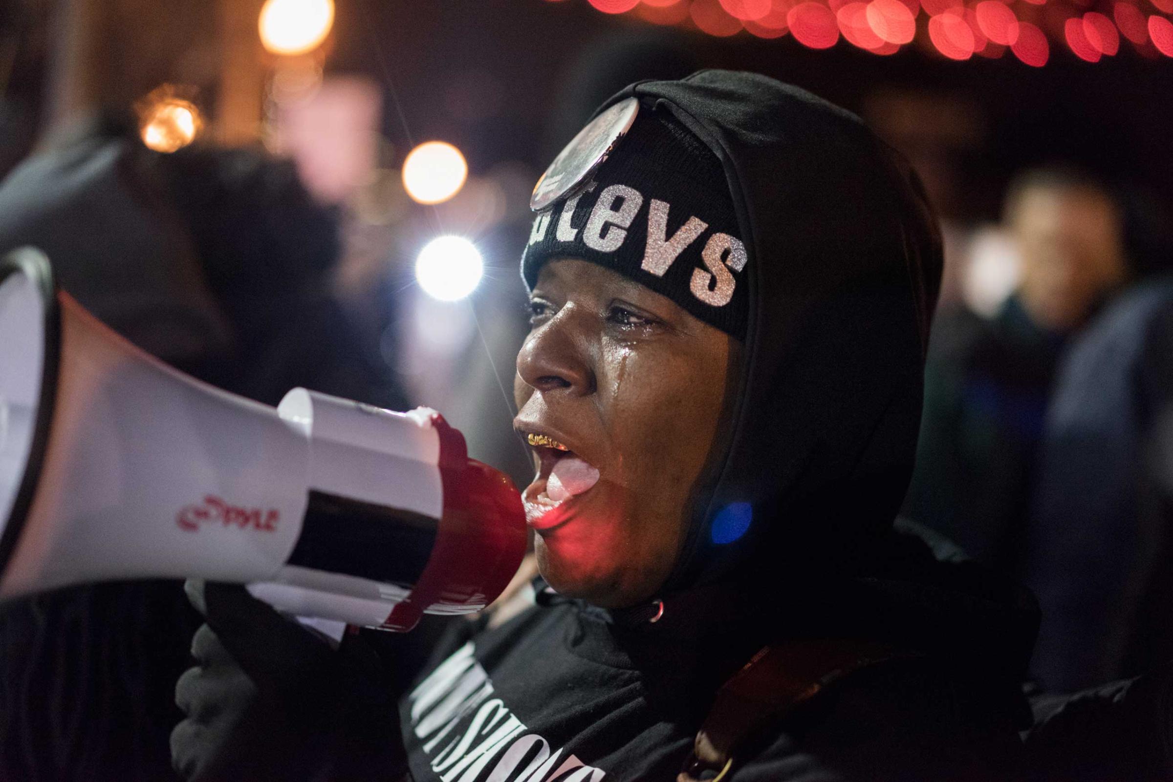 A woman speaks into a megaphone during protests in Ferguson, Mo. on Nov. 24, 2014