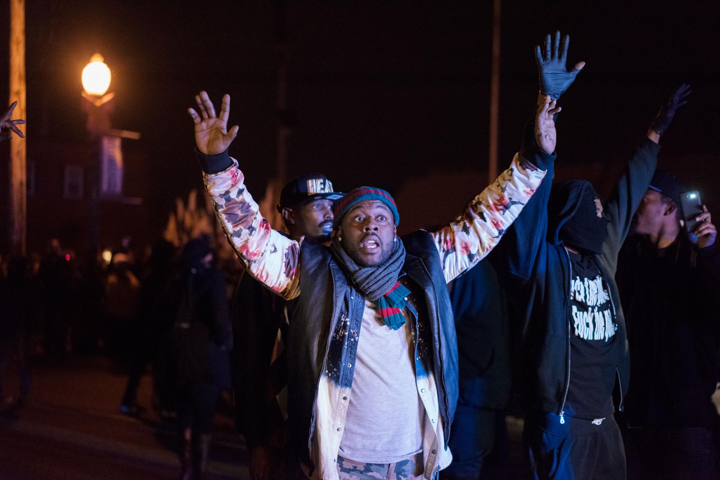 A demonstrator puts his hands in the air amid protests in Ferguson, Mo. on Nov. 24, 2014