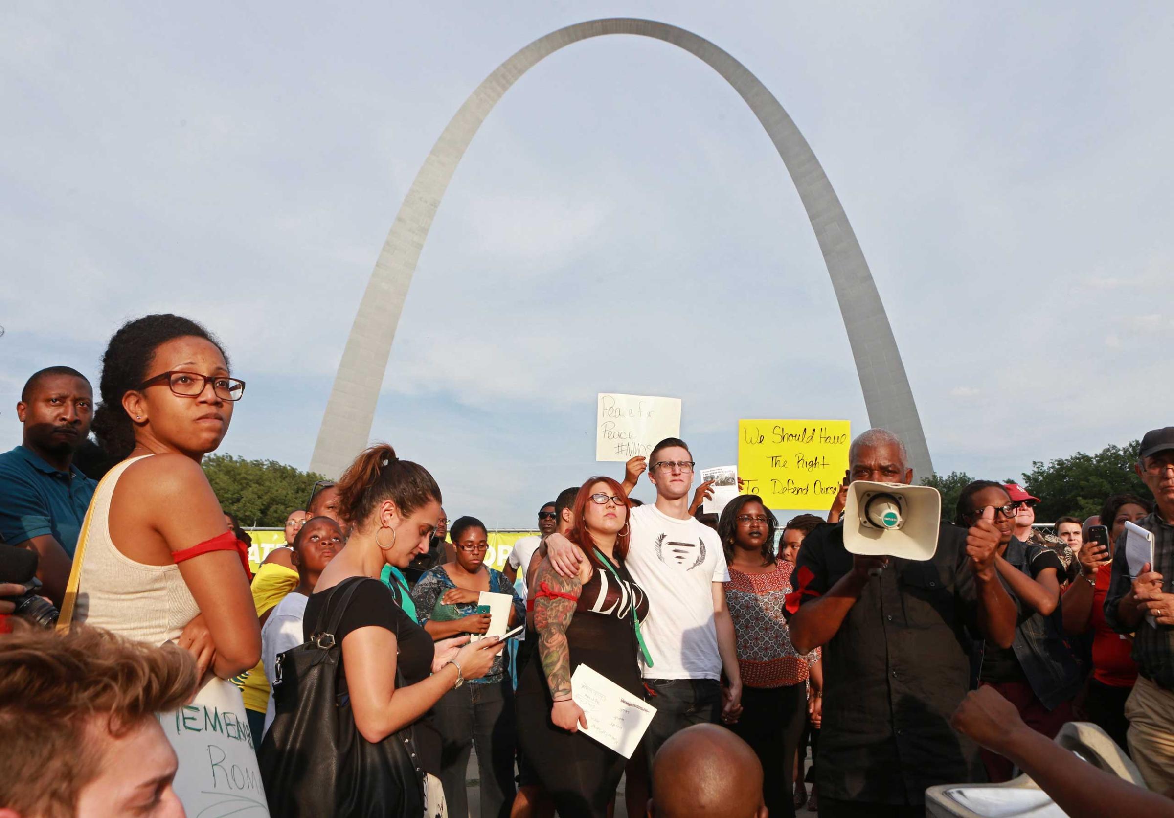 Aug. 14, 2014. A crowd of several hundred gatheres in a park near the Gateway Arch for a moment of silence on Thursday in St. Louis during a peace vigil and moment of silence for Michael Brown, an unarmed teenager who was shot and killed by Ferguson, Mo., police on Saturday.