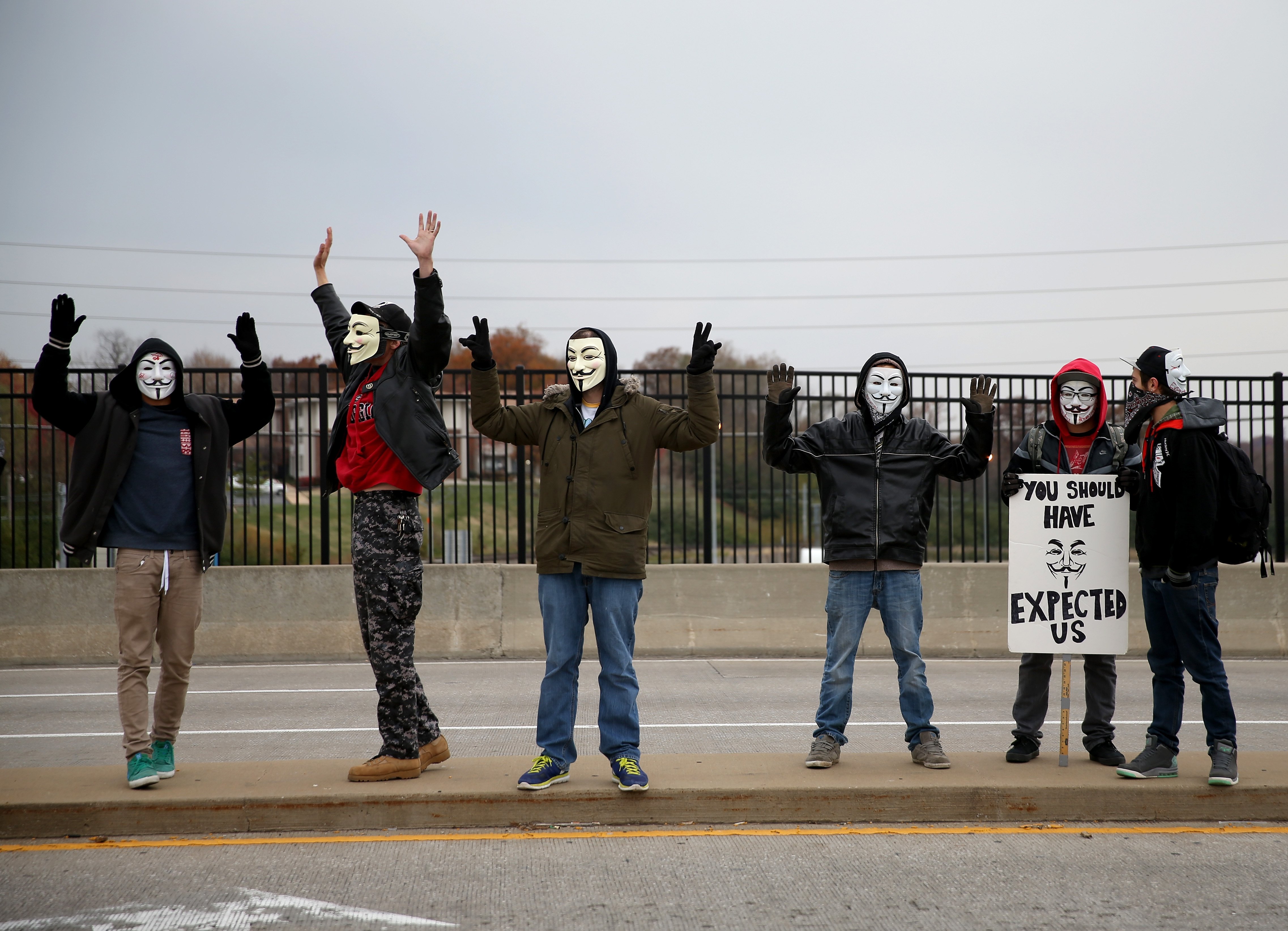 Demonstrators yell "Hands Up, Don't Shoot" alongside a highway overpass to voice their opinions as the area awaits a grand jury decision on Nov. 15, 2014 near Ferguson, Missouri. (Joe Raedle—`Getty Images)