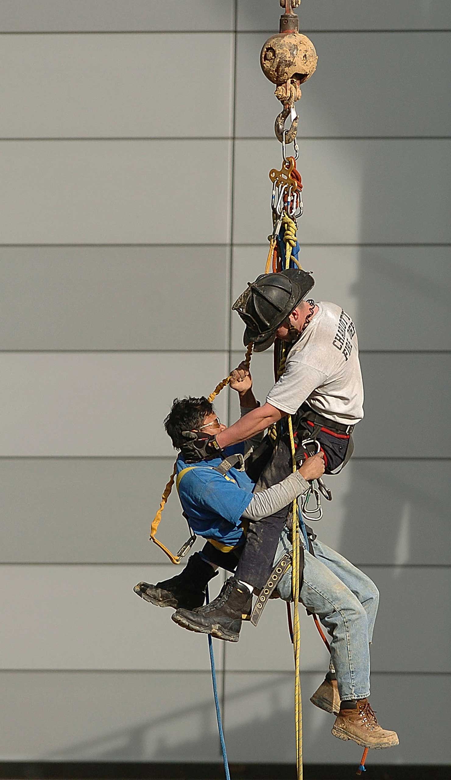 Firefighter Billy Mitchell rescues an injured construction worker in Uptown Charlotte on Feb. 23, 2005.