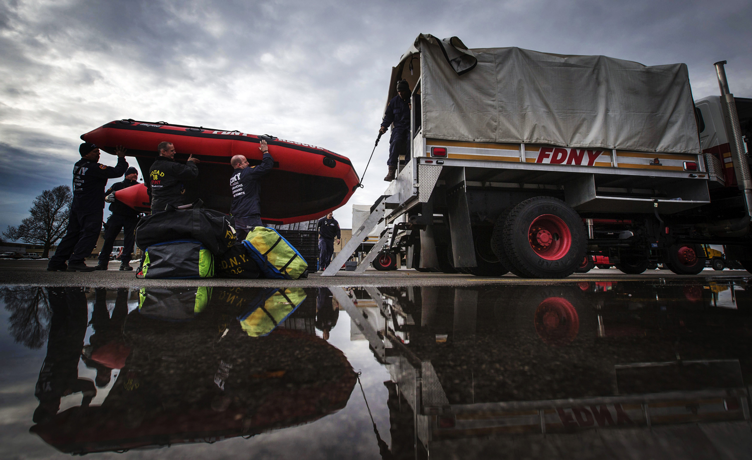 FDNY firefighters from New York City load a rescue boat to prepare for possible flooding following a massive snow storm in Williamsville