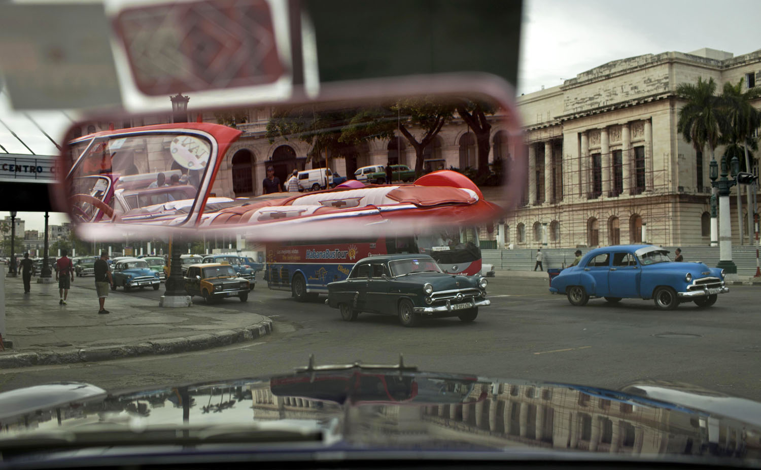 People drive classic American car in Old Havana, Cuba, Oct. 16, 2014.