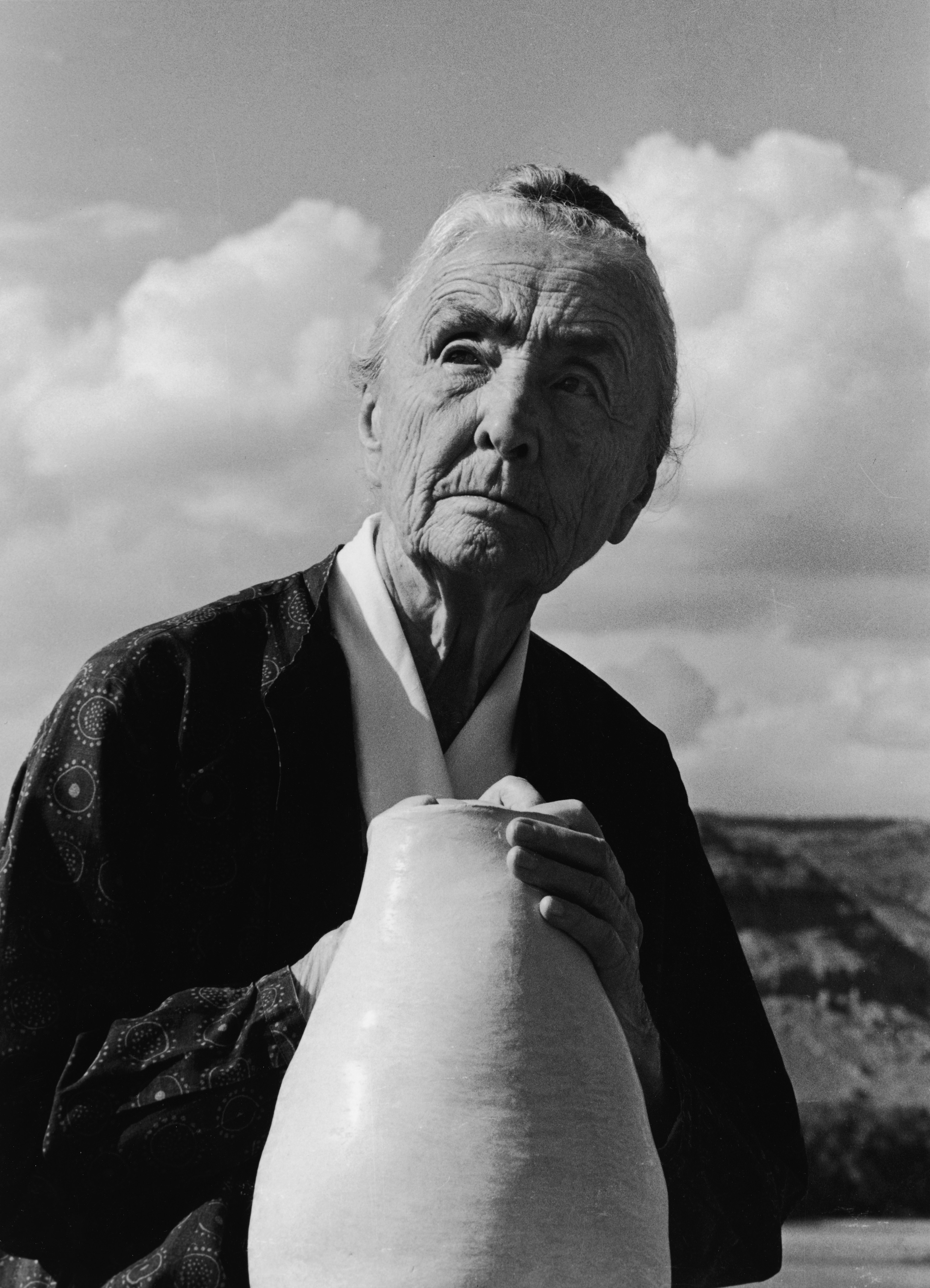 American artist Georgia O'Keeffe looks off into the distance with her hands on a piece of pottery, Abiquiu, New Mexico, 1974. (Joe Munroe&amp;mdash;Getty Images)