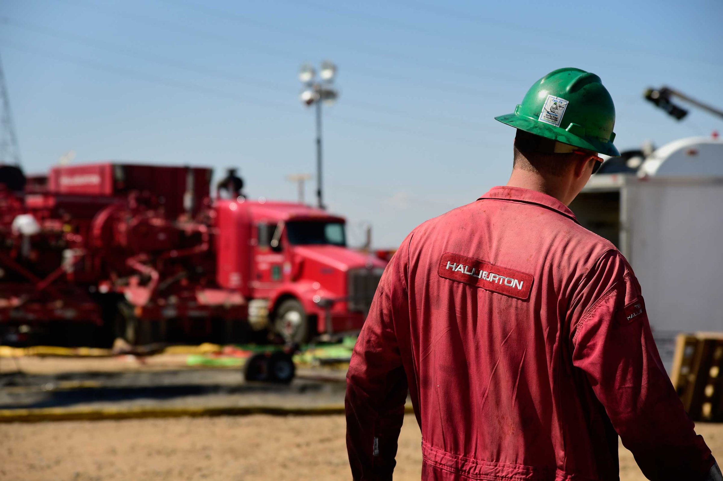 A Halliburton Co. worker walks through an Anadarko Petroleum Corp. hydraulic fracturing (fracking) site north of Dacono, Colo. on Aug. 12, 2014.