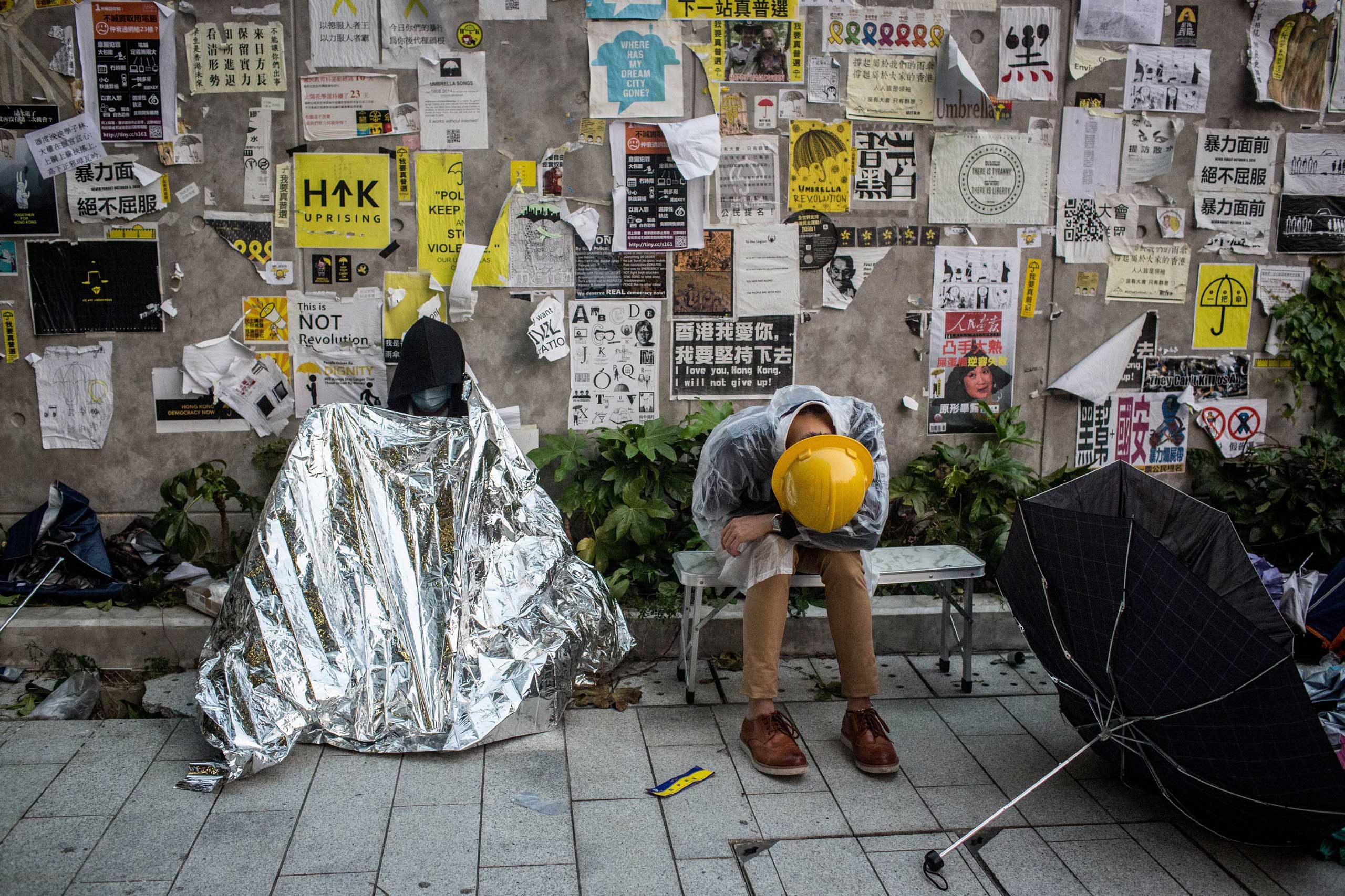 Pro-democracy activists sleep outside the Legislative Council building after protesters clashed with police on Nov. 19, 2014, in Hong Kong.