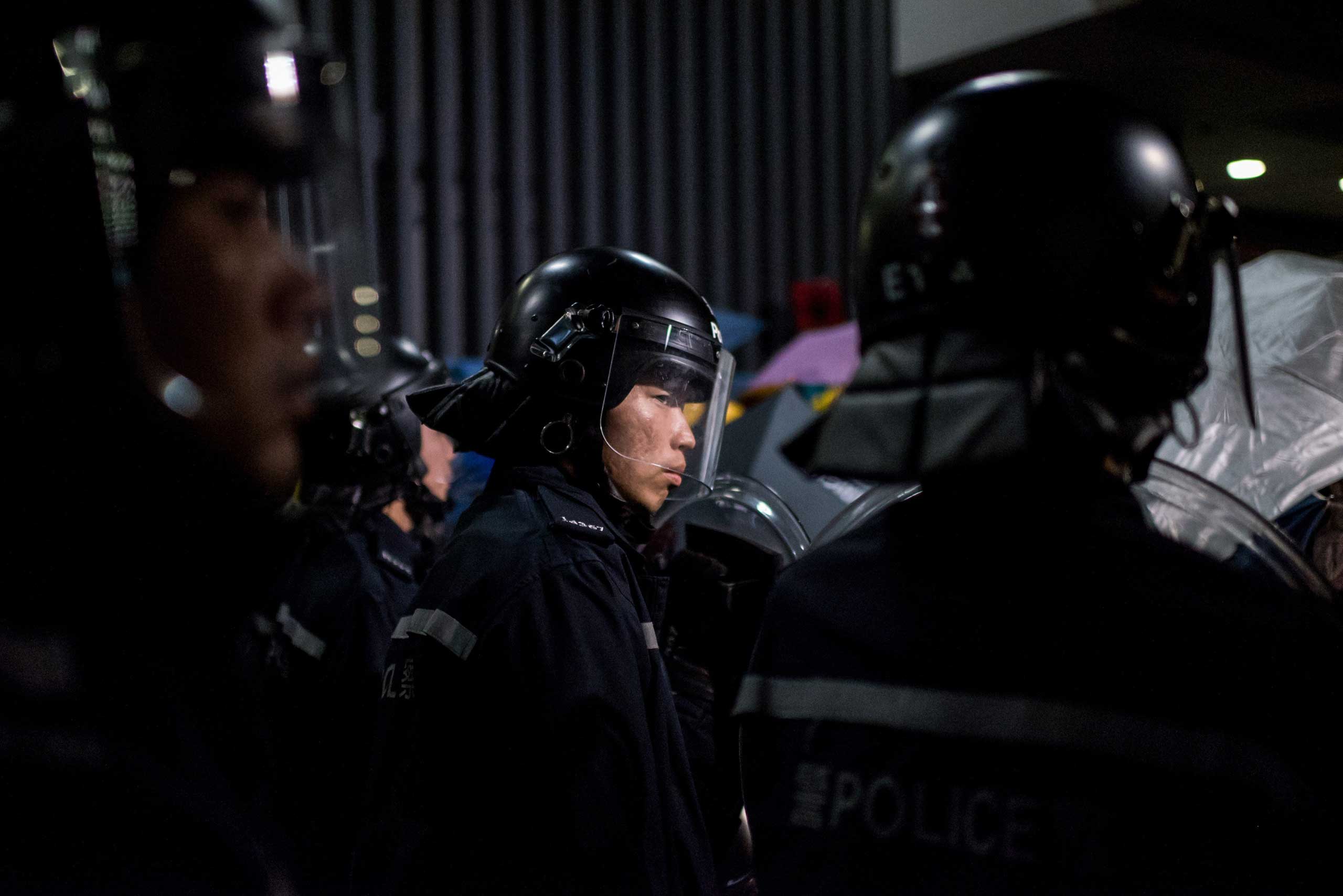 Police face pro-democracy protesters on Nov. 19, 2014, outside the central government offices in the Admiralty district of Hong Kong.