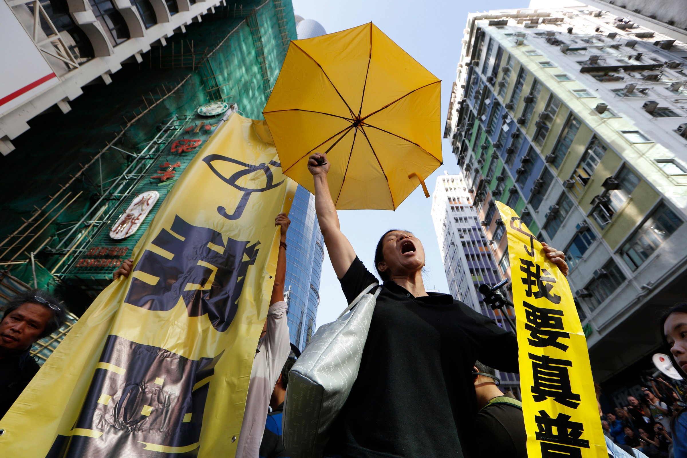 A pro-democracy protester chants at an occupied area before the barricade is removed in Mong Kok district of Hong Kong on Nov. 25, 2014.
