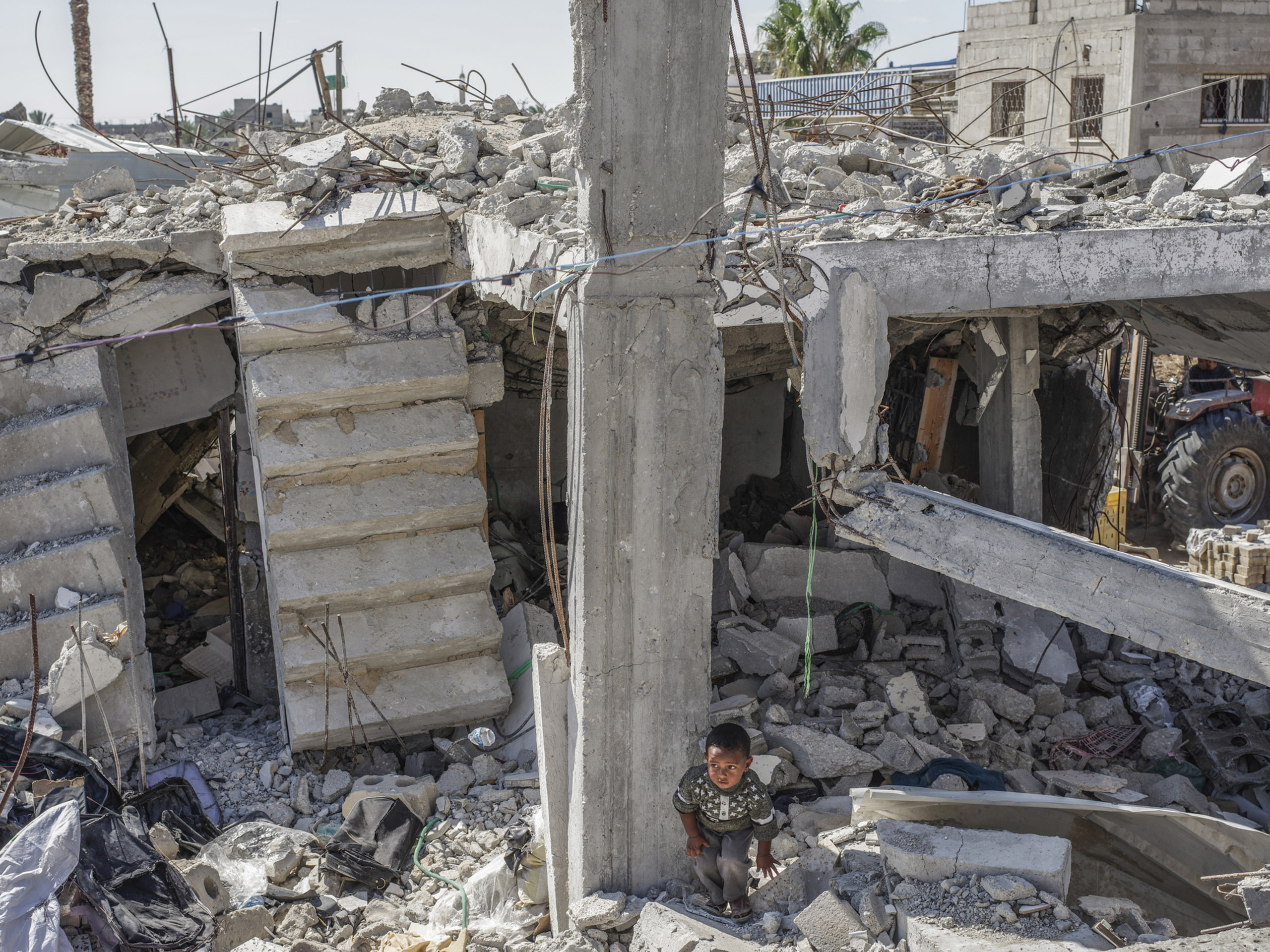 A child in the ruins of his home in the destroyed neighborhood of Beit Hanoun, Gaza.
