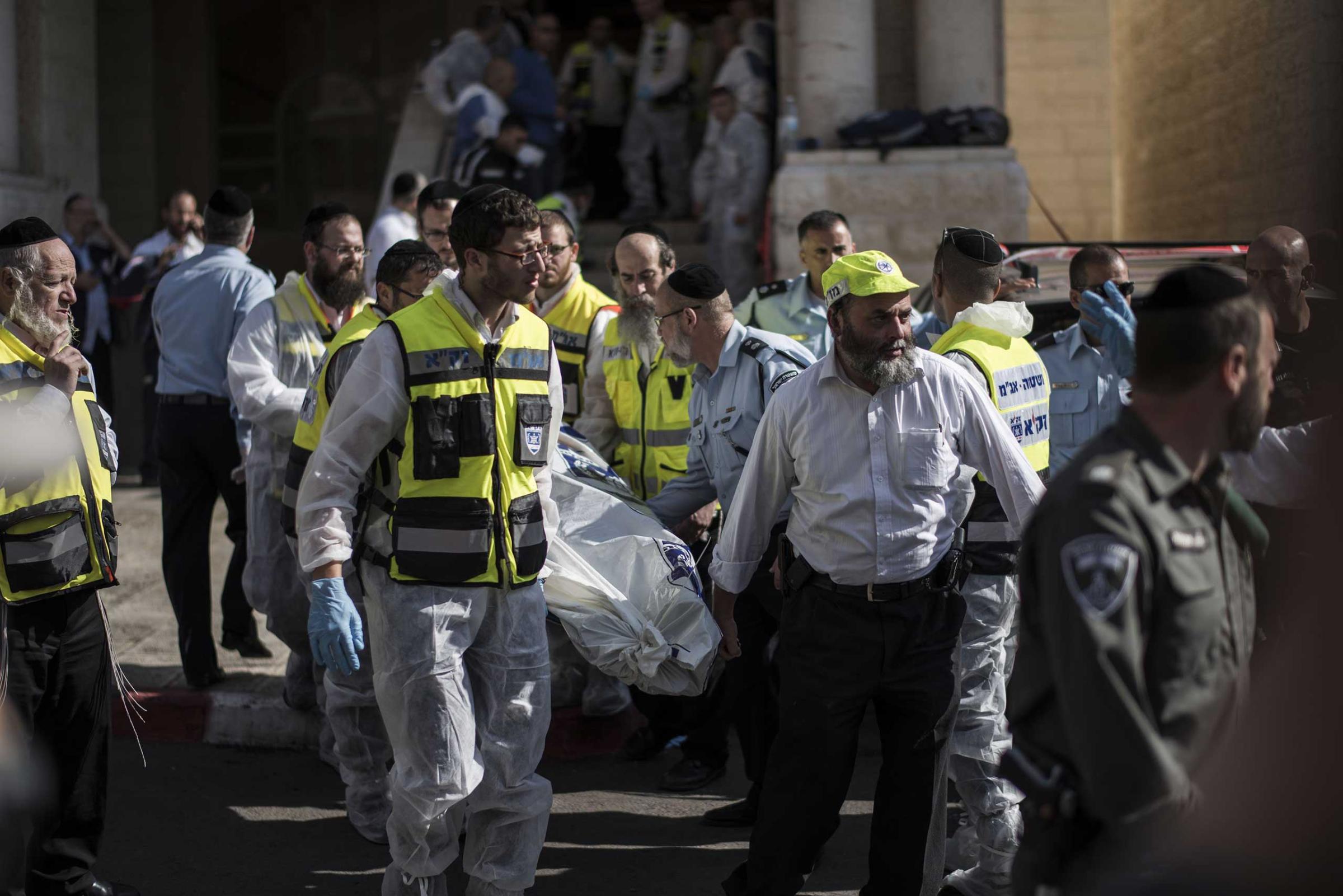 Israeli emergency personnel take out a body of an Israeli man outside a synagogue on Nov. 18, 2014 in Jerusalem.