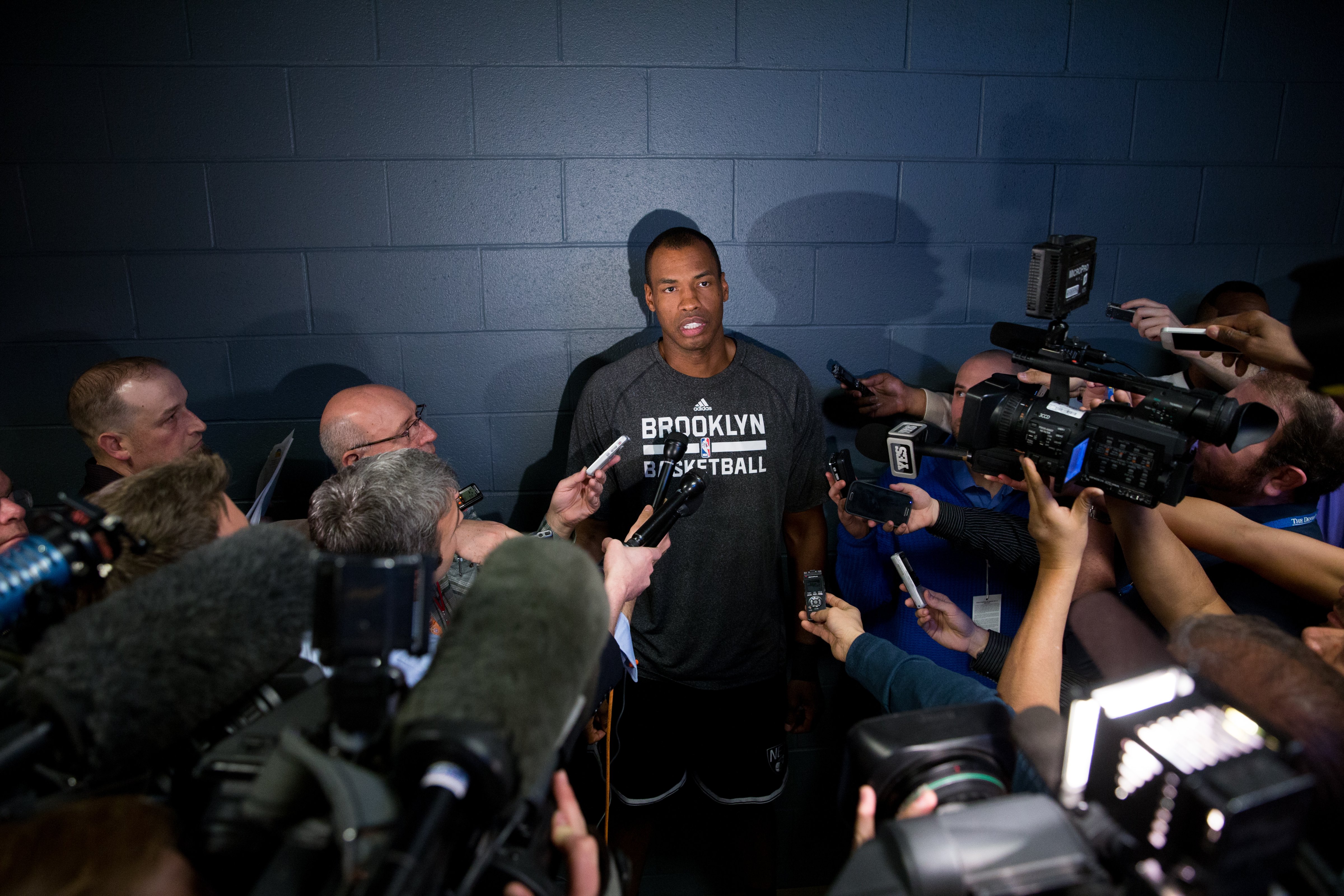 Jason Collins #98 of the Brooklyn Nets speaks with the media prior to a game against the Denver Nuggets at Pepsi Center on Feb. 27, 2014 in Denver. (Justin Edmonds—Getty Images)