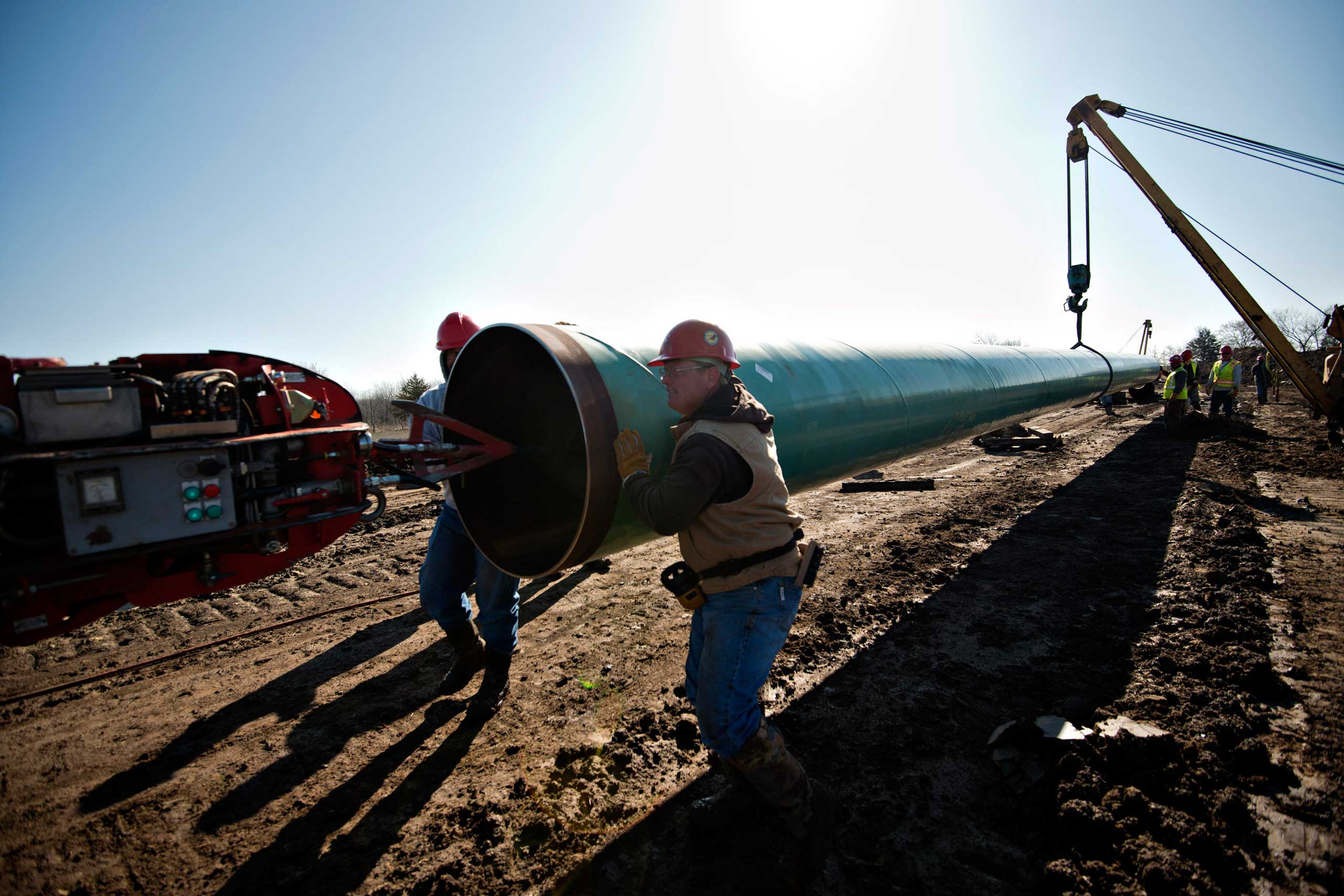 Workers move a section of pipe during construction of the Gulf Coast Project pipeline, part of the Keystone XL Pipeline Project, in Atoka, Okla. on March 11, 2013. (Daniel Acker—Bloomberg/Getty Images)