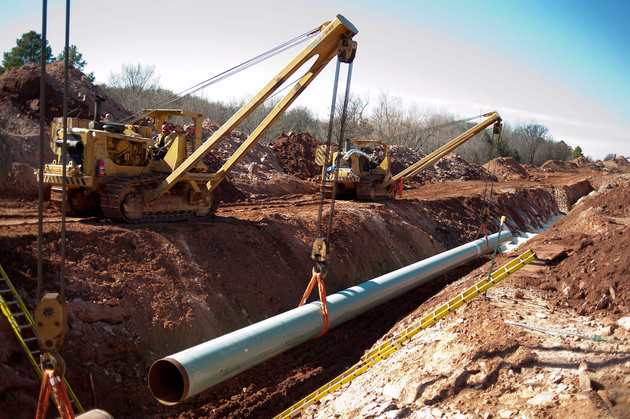 A sixty-foot section of pipe is lowered into a trench during construction of the Gulf Coast Project pipeline in Prague, Oklahoma, U.S., on March 11, 2013. (Daniel Acker—Bloomberg/Getty Images)
