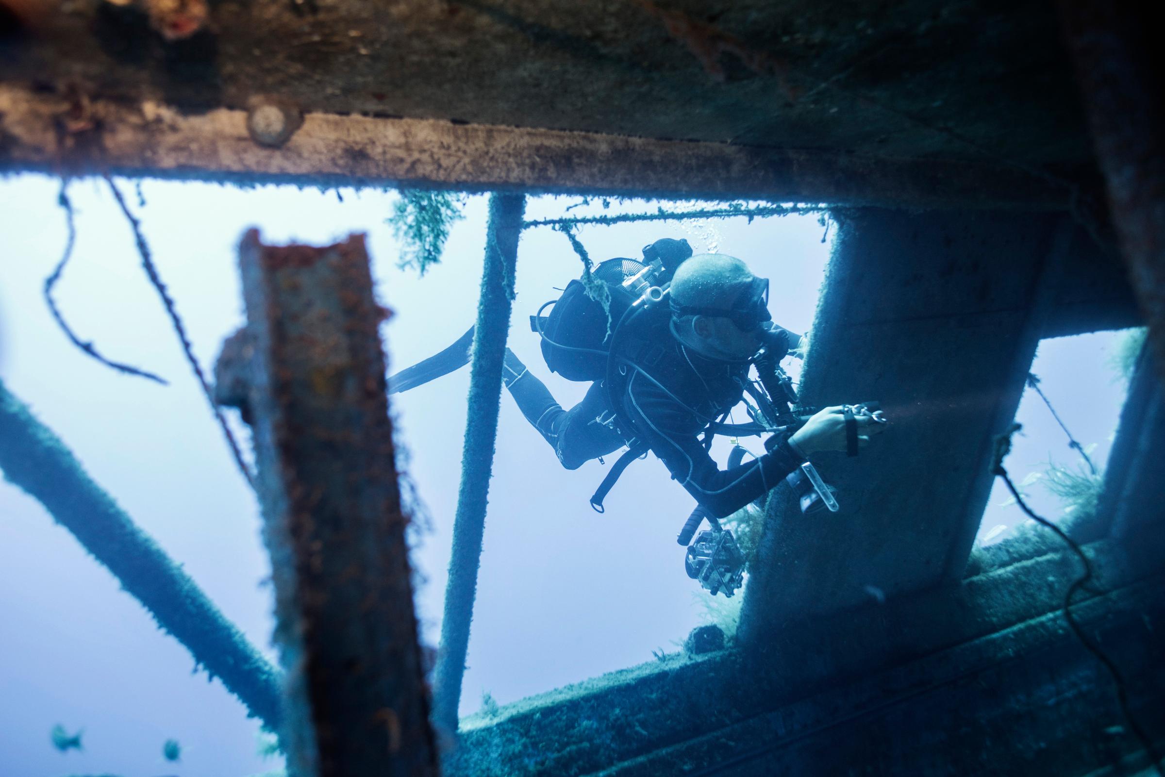 A scuba-diver enters the shipwreck that sank off the coast of the Italian island of Lampedusa lies at a depth of 164 ft. on the seabed, on Sept. 22, 2014. The tragedy that happened a year ago on Oct. 3, 2013 killed 366 migrants from North Africa.
